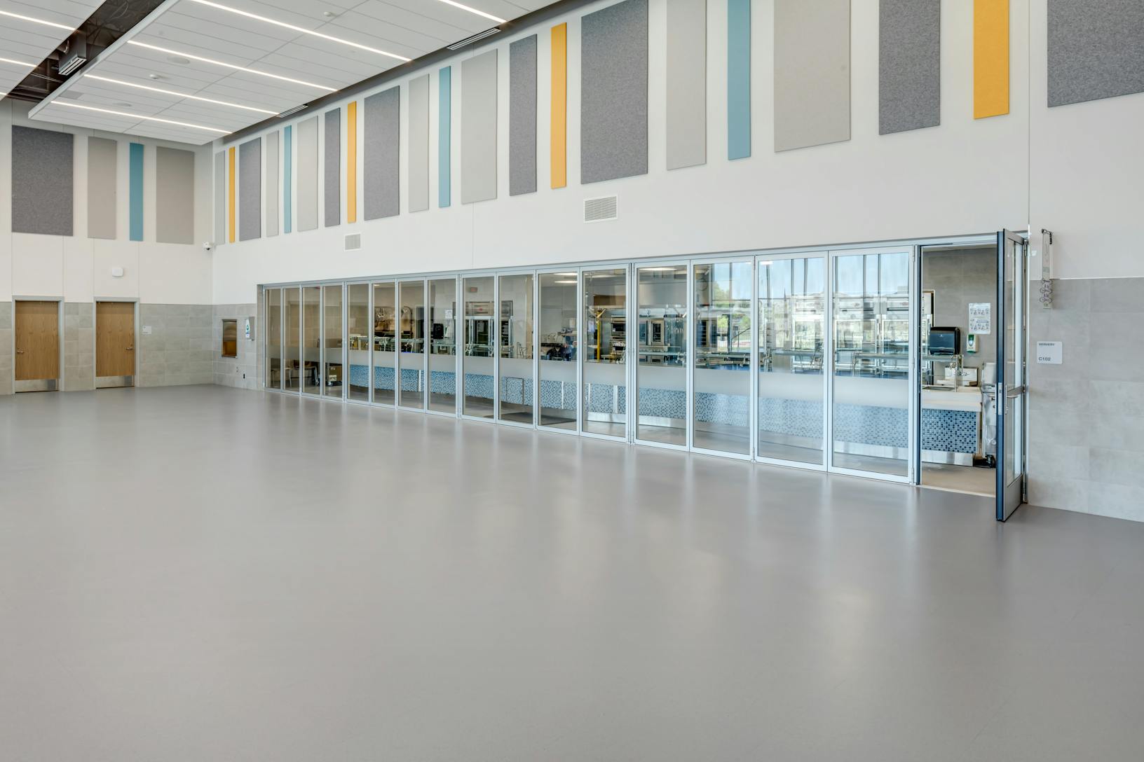 Acoustical movable glass walls at Minett Elementary school - swing door