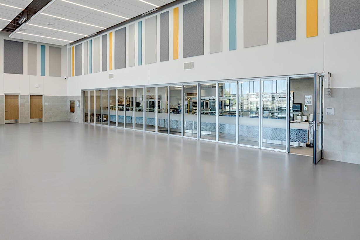 Acoustical movable glass walls at Minett Elementary school - swing door