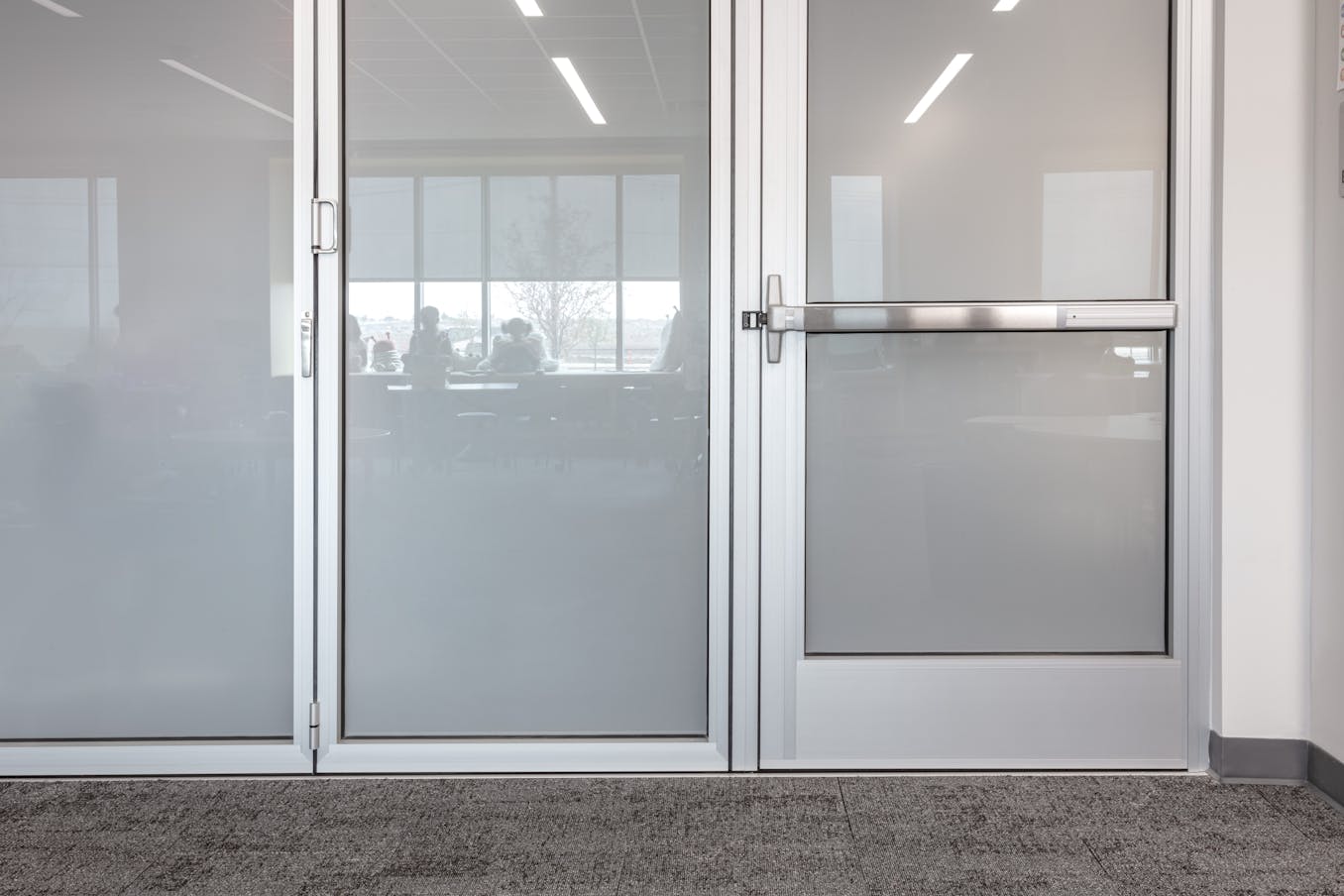 A classroom featuring frosted glass doors and panic hardware