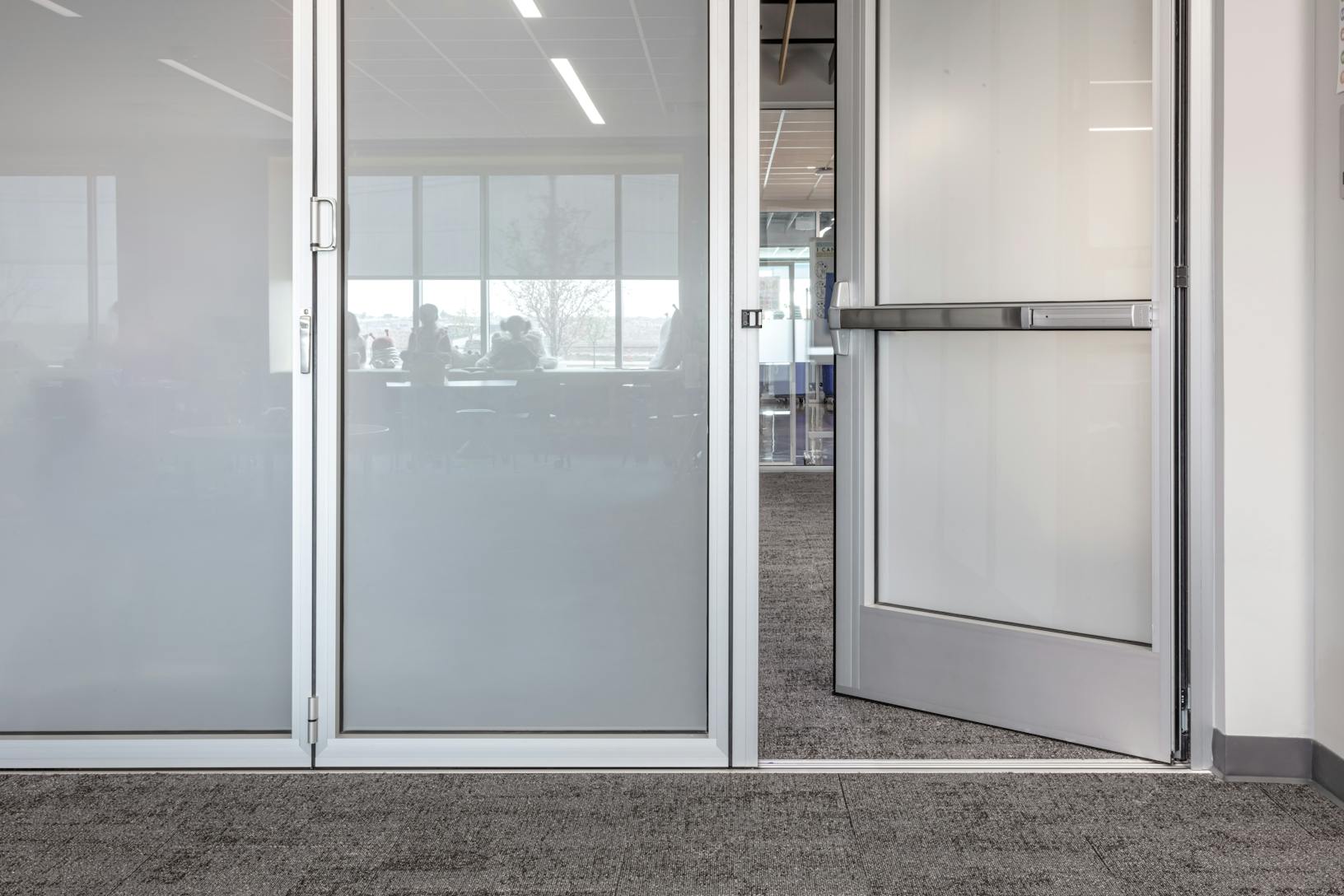 Acoustical movable glass walls at Minett Elementary- Swing door