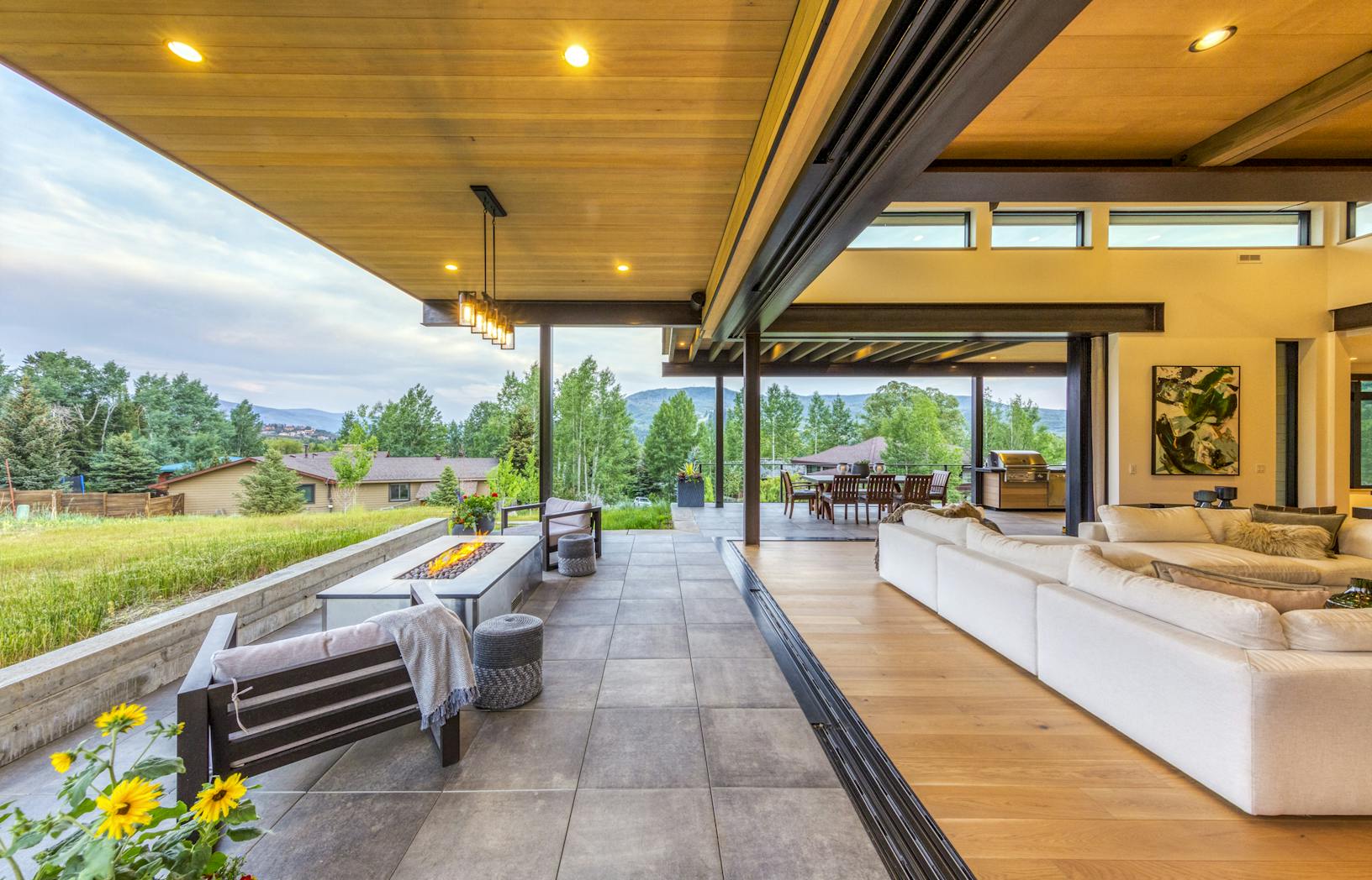 A modern home with a large deck and outdoor furniture