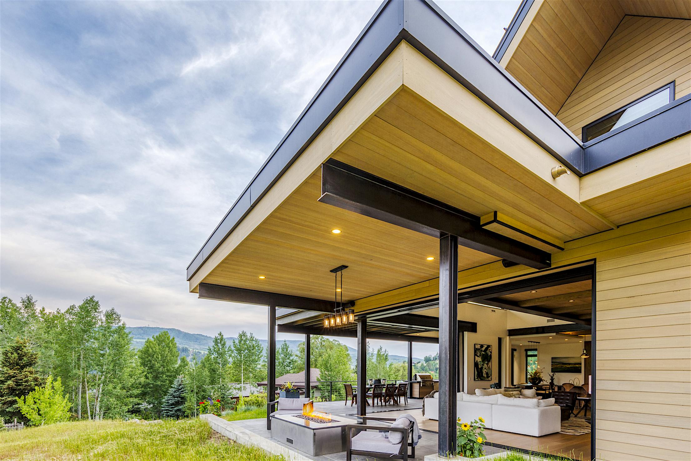 A modern home with a large patio sliding doors and grassy yard