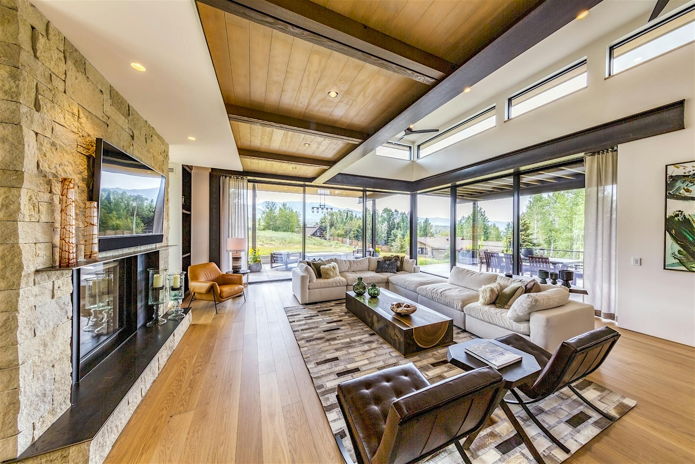 A large living room with a fireplace and large panel sliding doors