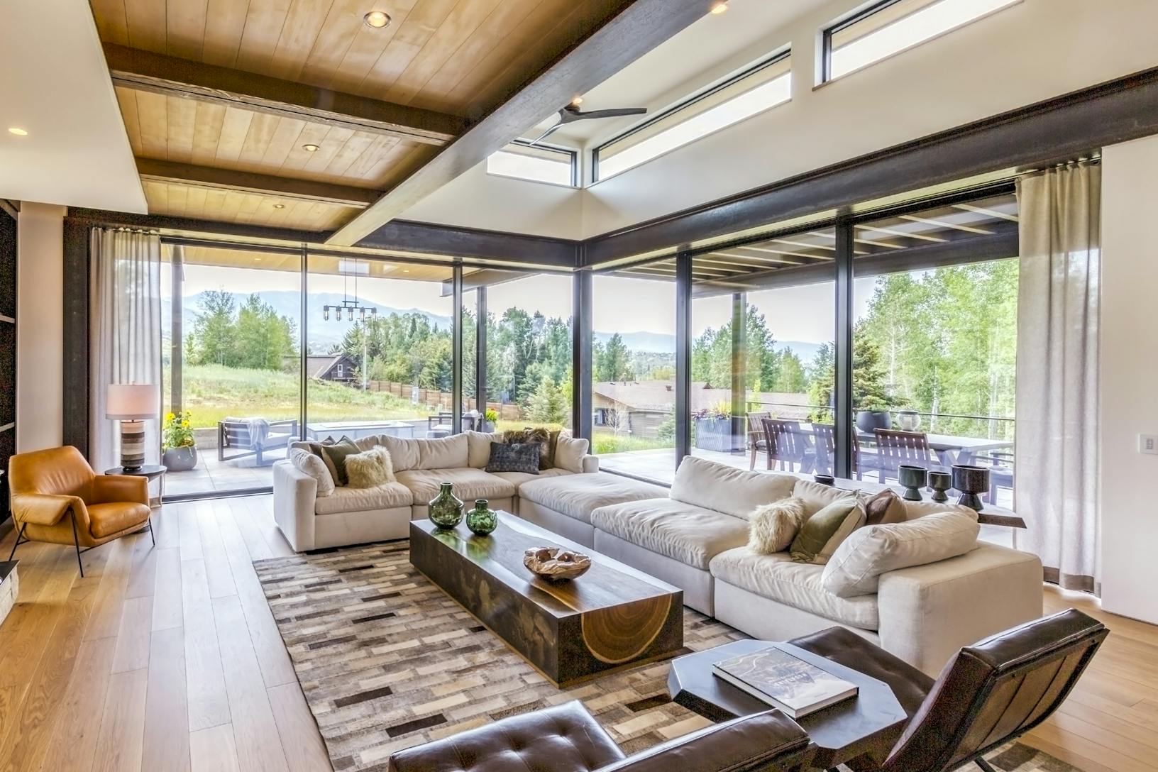 A living room with Large Panel Minimal Sliding Glass Walls, offering breathtaking views of the mountains. A living room with large panel minimal sliding glass walls, offering breathtaking views of the mountains