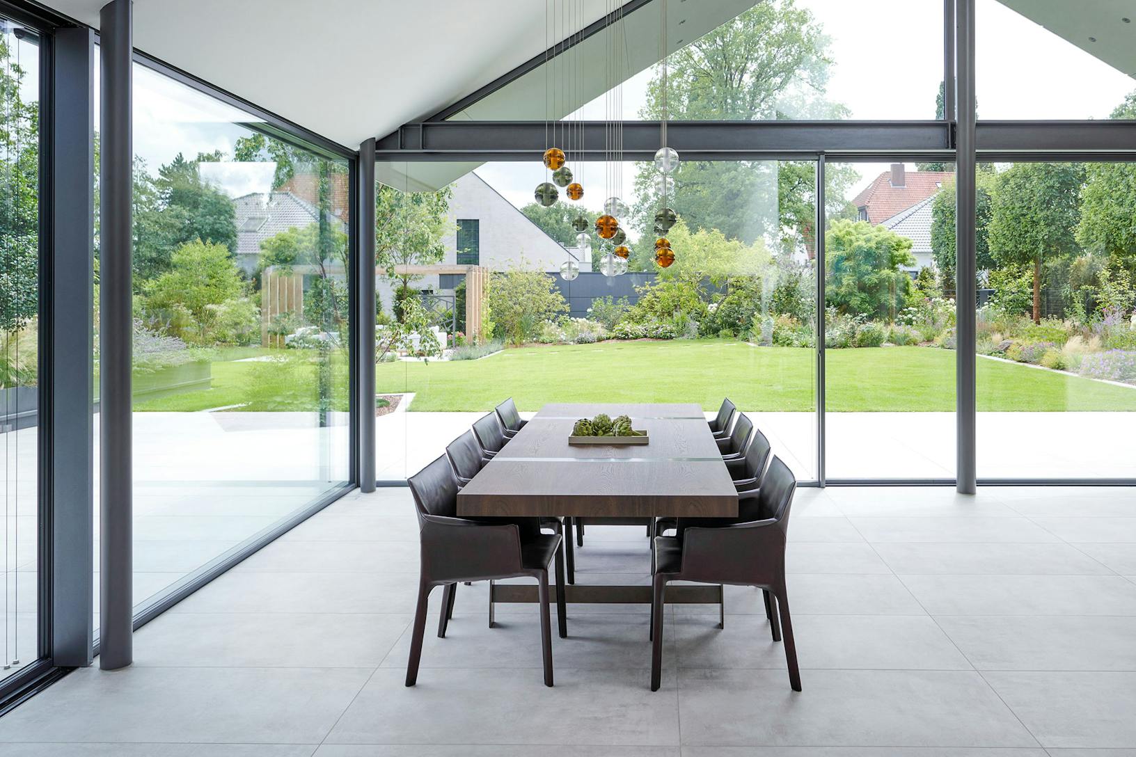 A modern dining room with glass walls