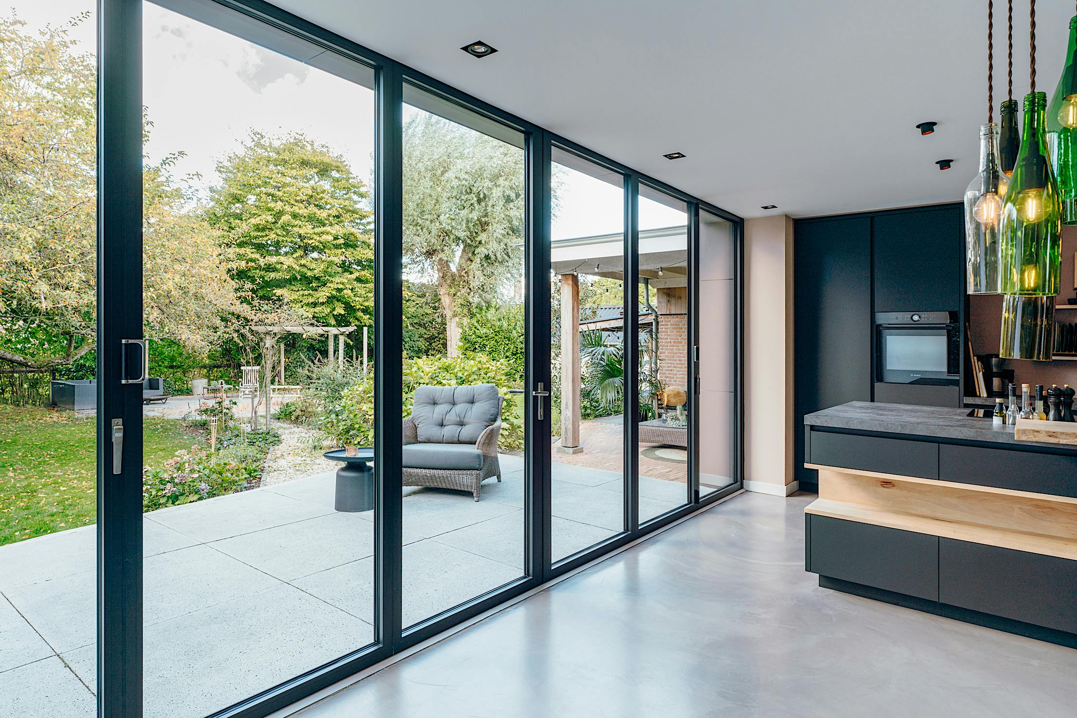 A modern kitchen with closed large glass doors