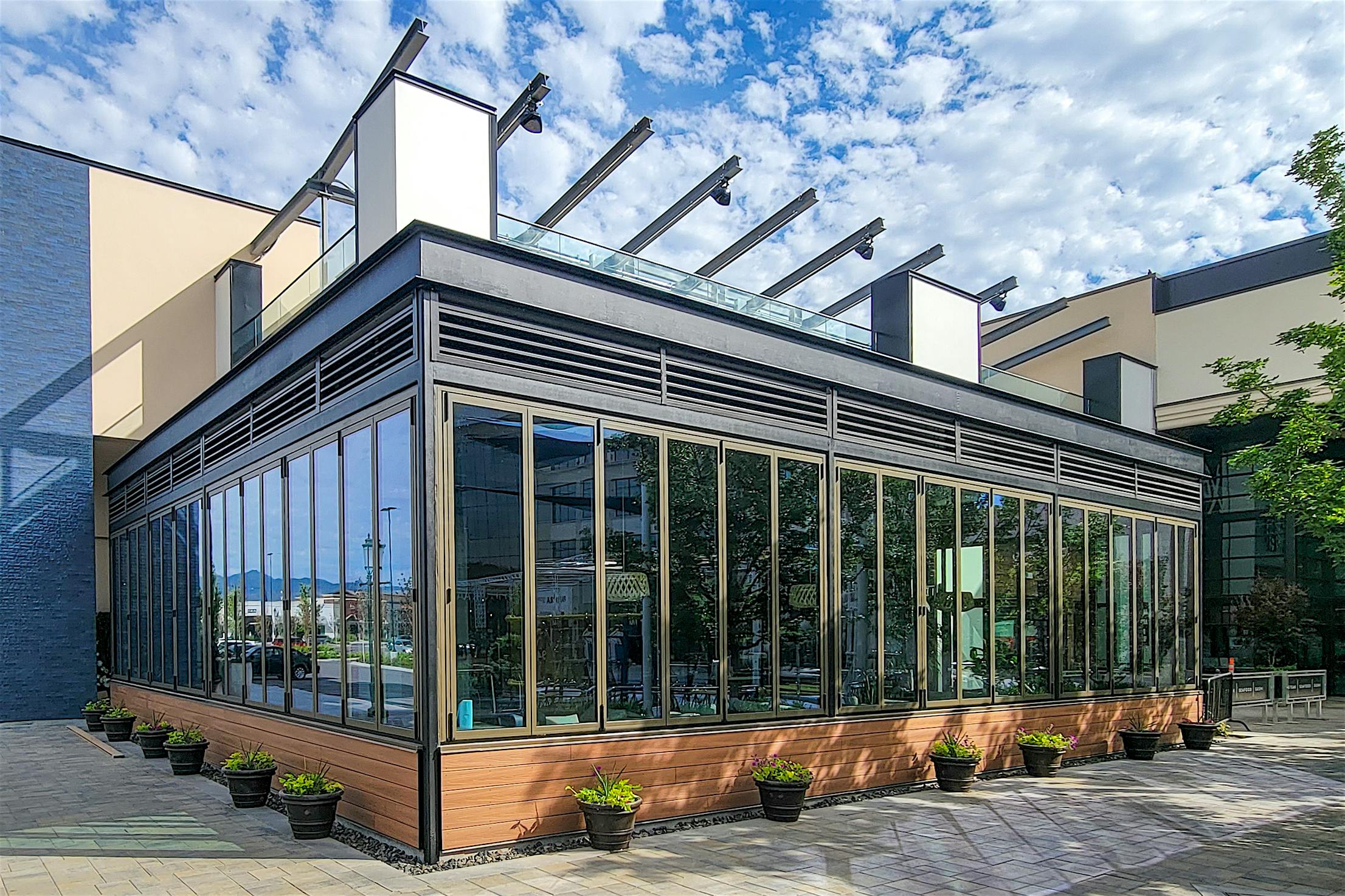 Modern glass-enclosed building with large folding windows