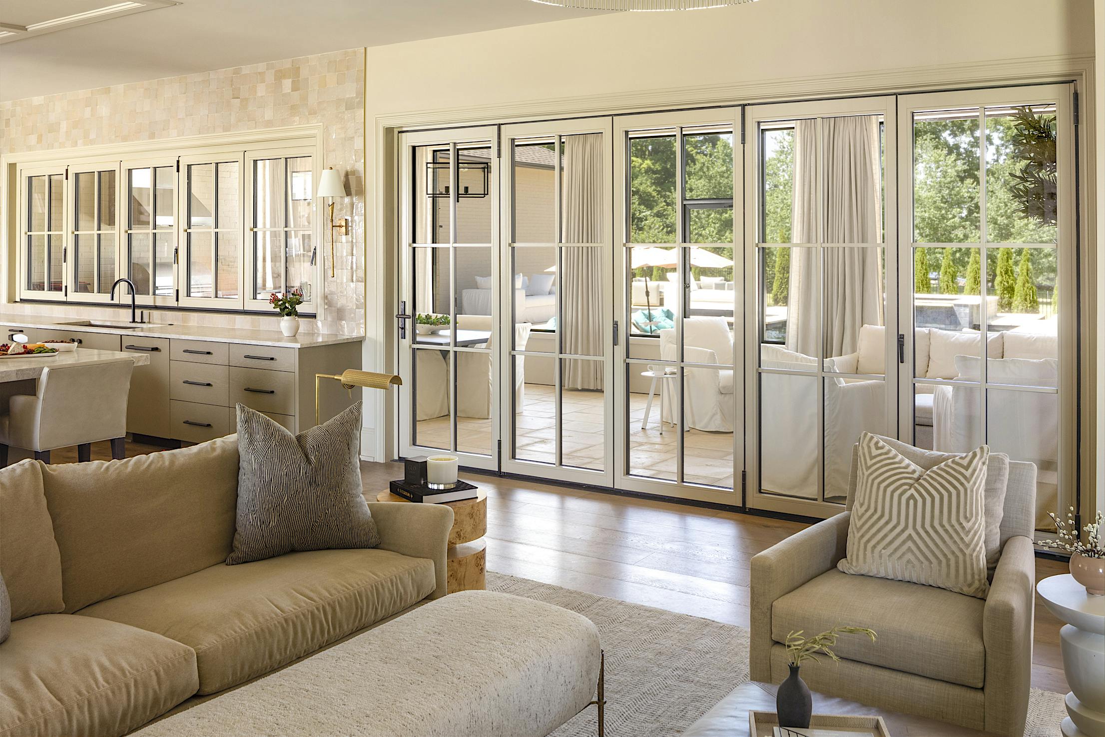 A living room with sliding glass doors, allowing for a seamless connection to the dining room and kitchen
