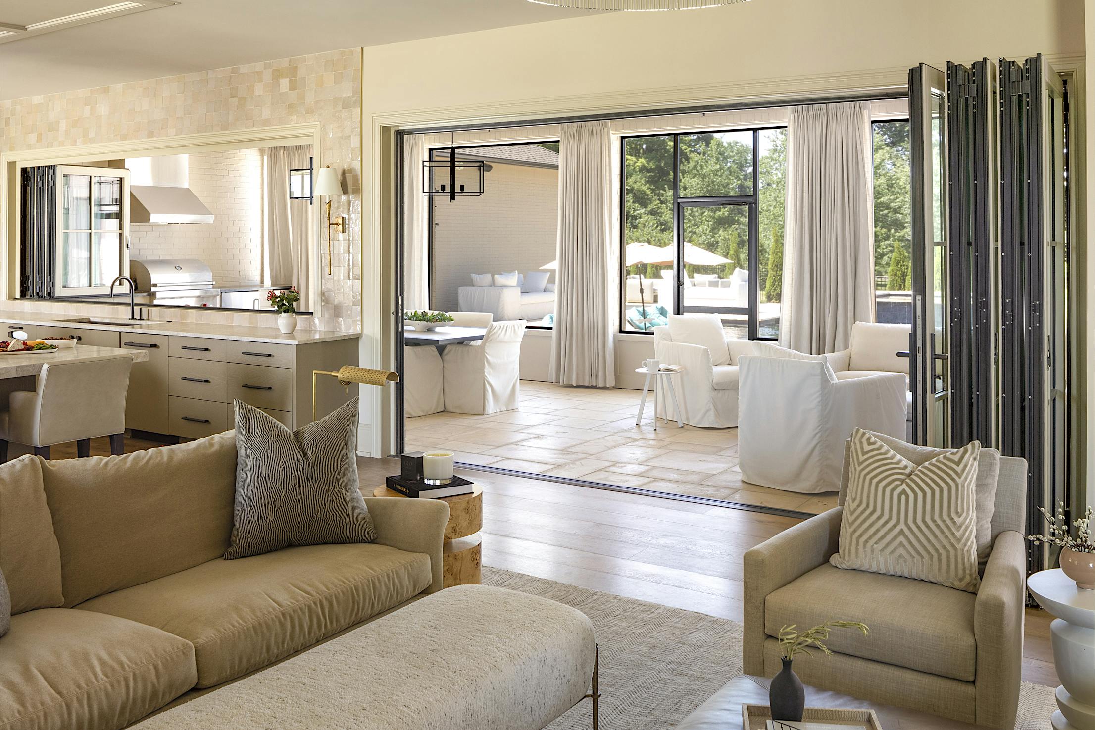 A beige couch in a living room with glass walls