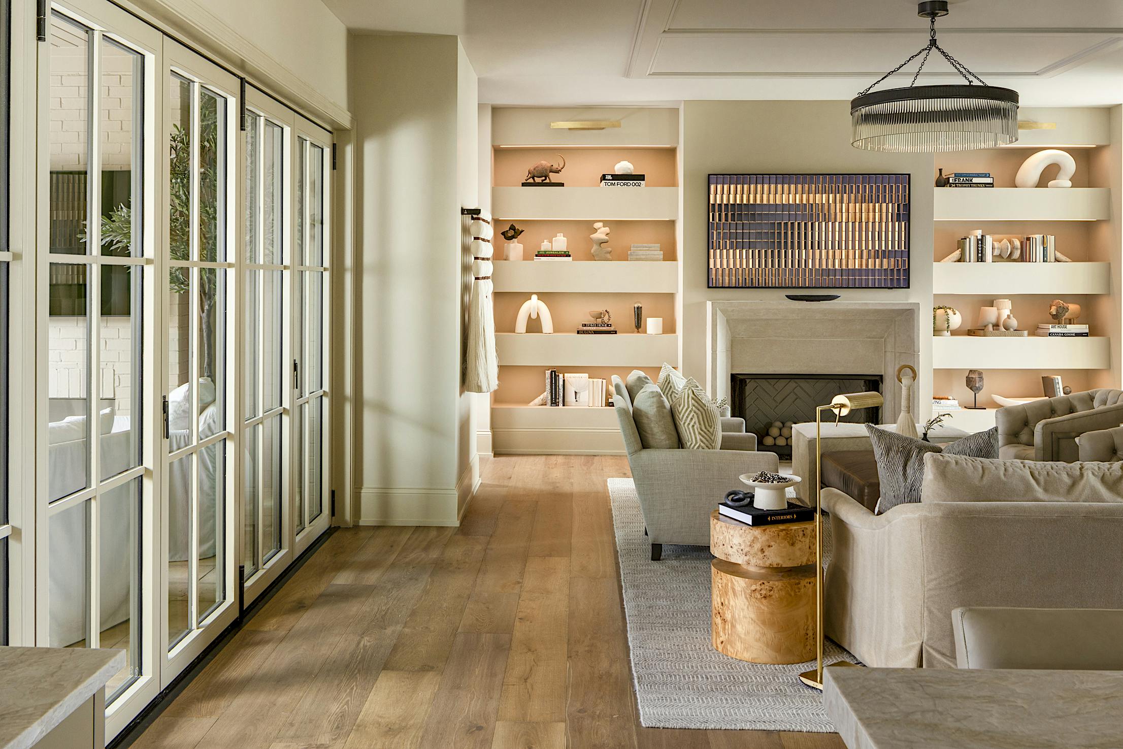 A living room with folding glass doors and a fireplace