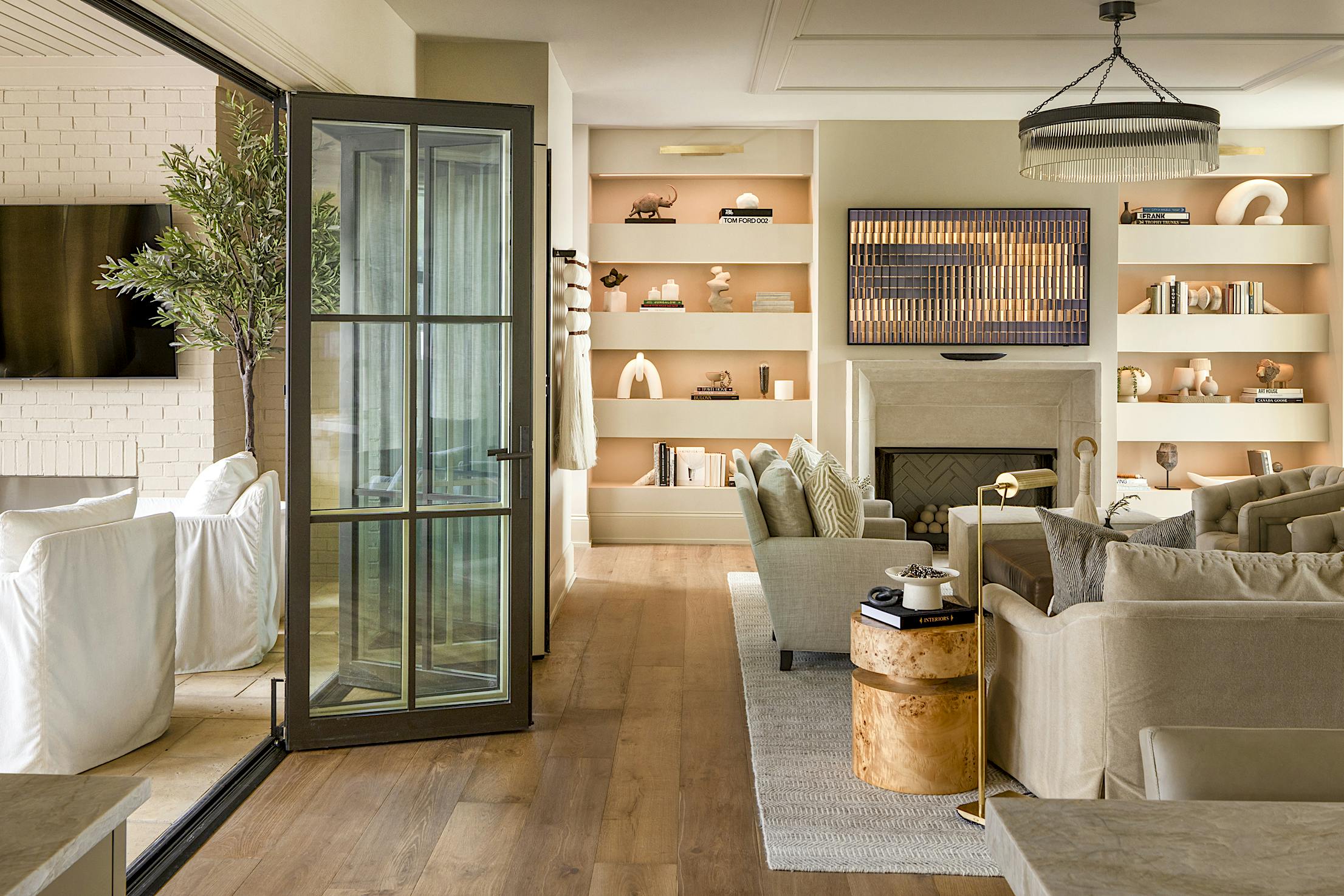 A living room with a folding glass door, providing a seamless connection to the outdoors