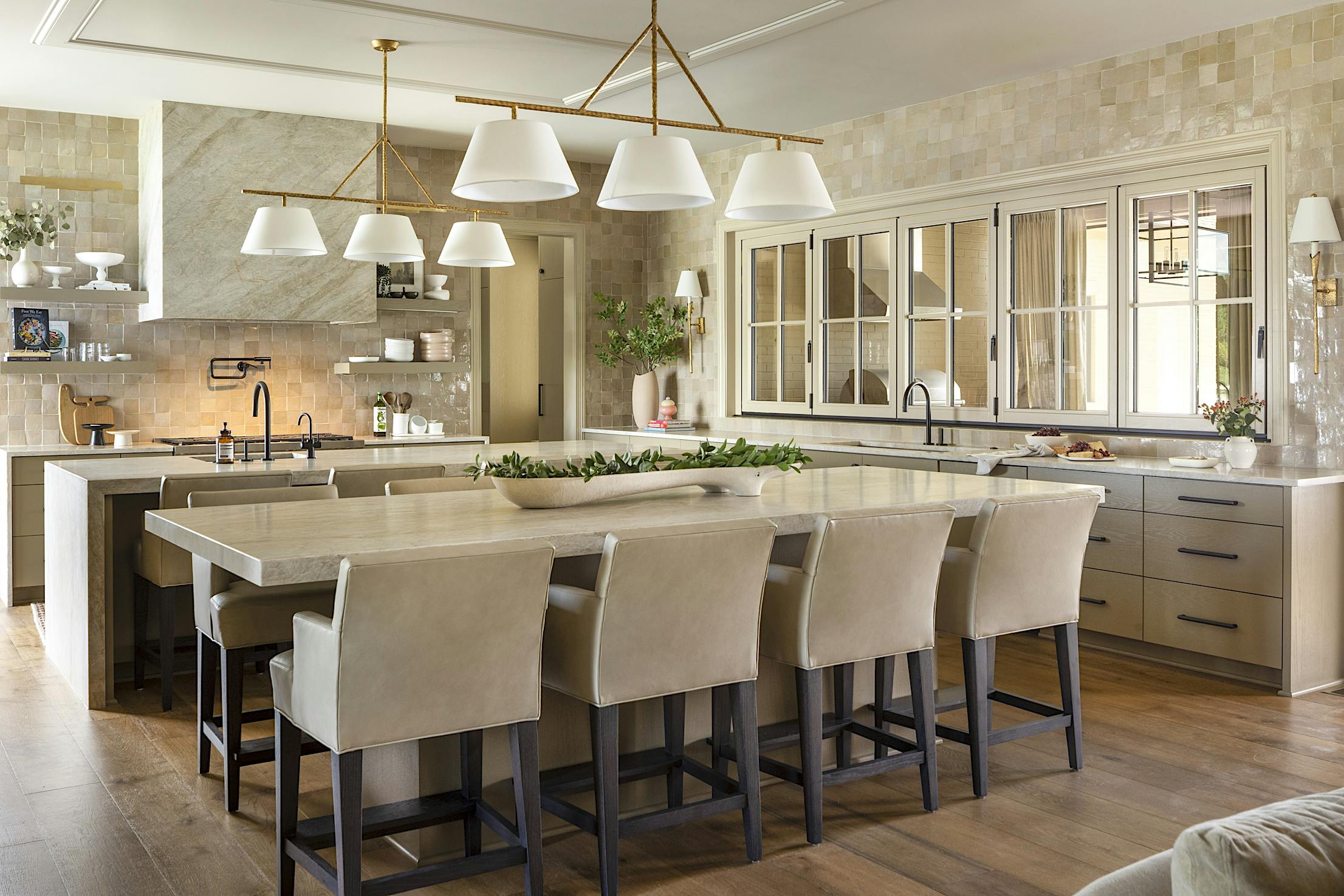 A large kitchen with a center island and closed glass wall panels