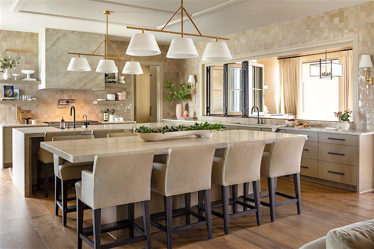 A spacious kitchen with a center island and folding glass windows