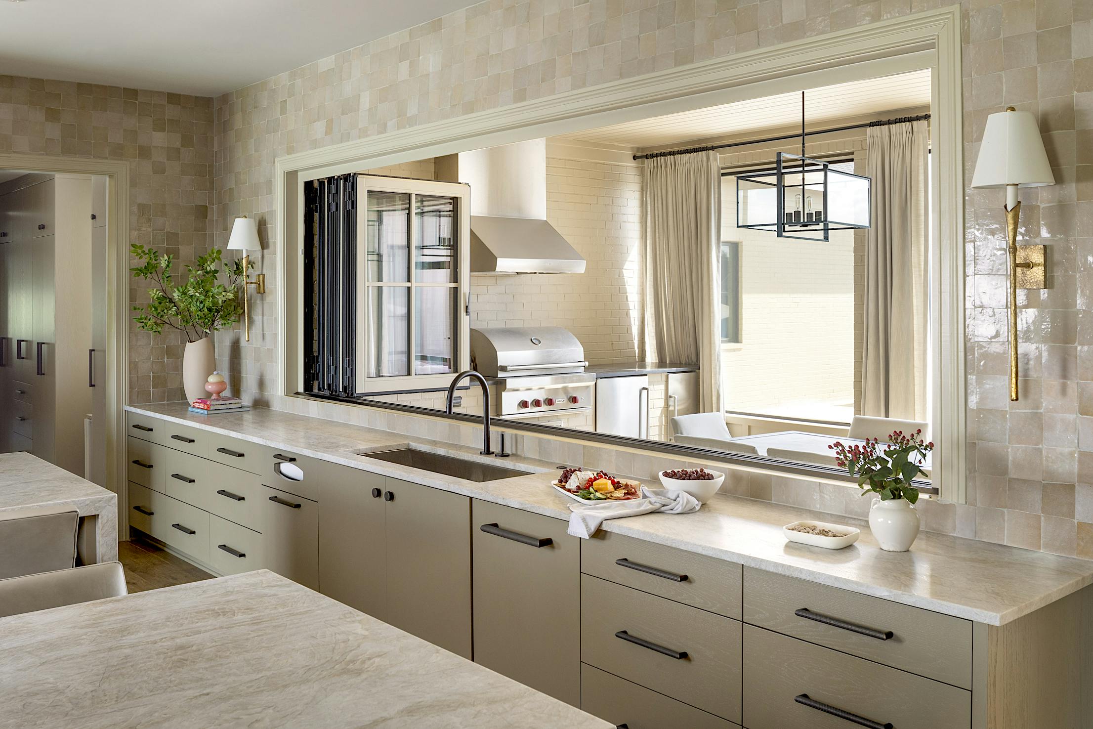 A kitchen with glass walls and counter tops