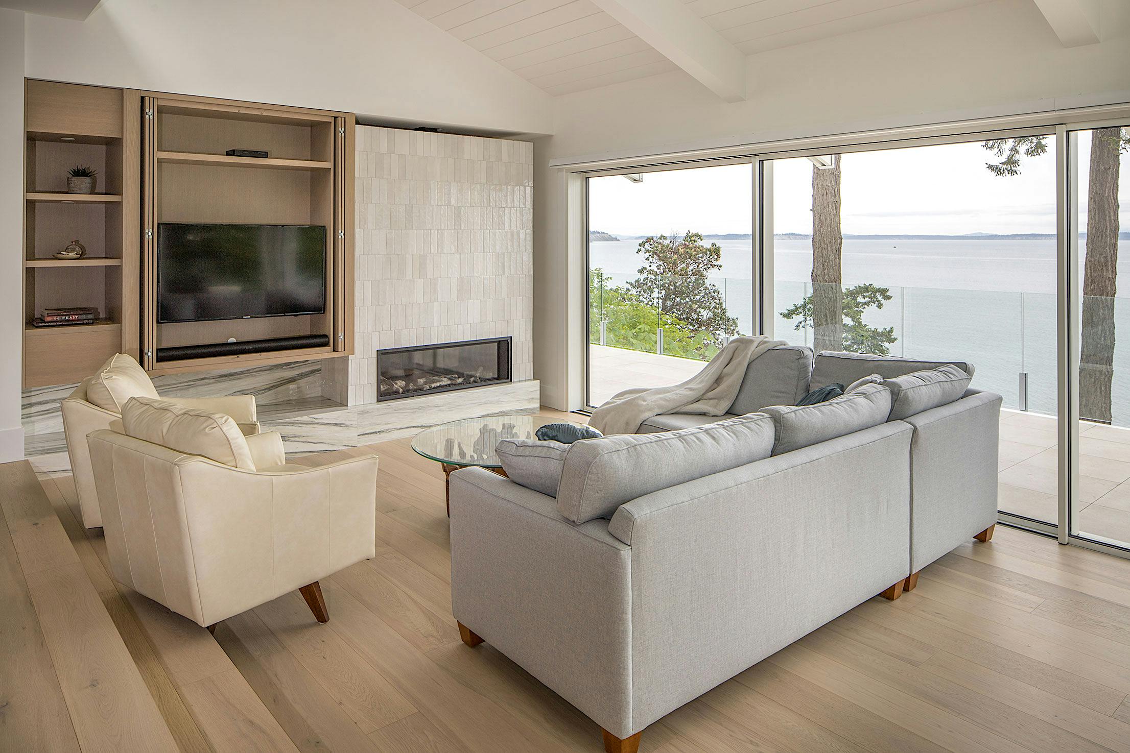 Modern living room with large opening minimal glass walls