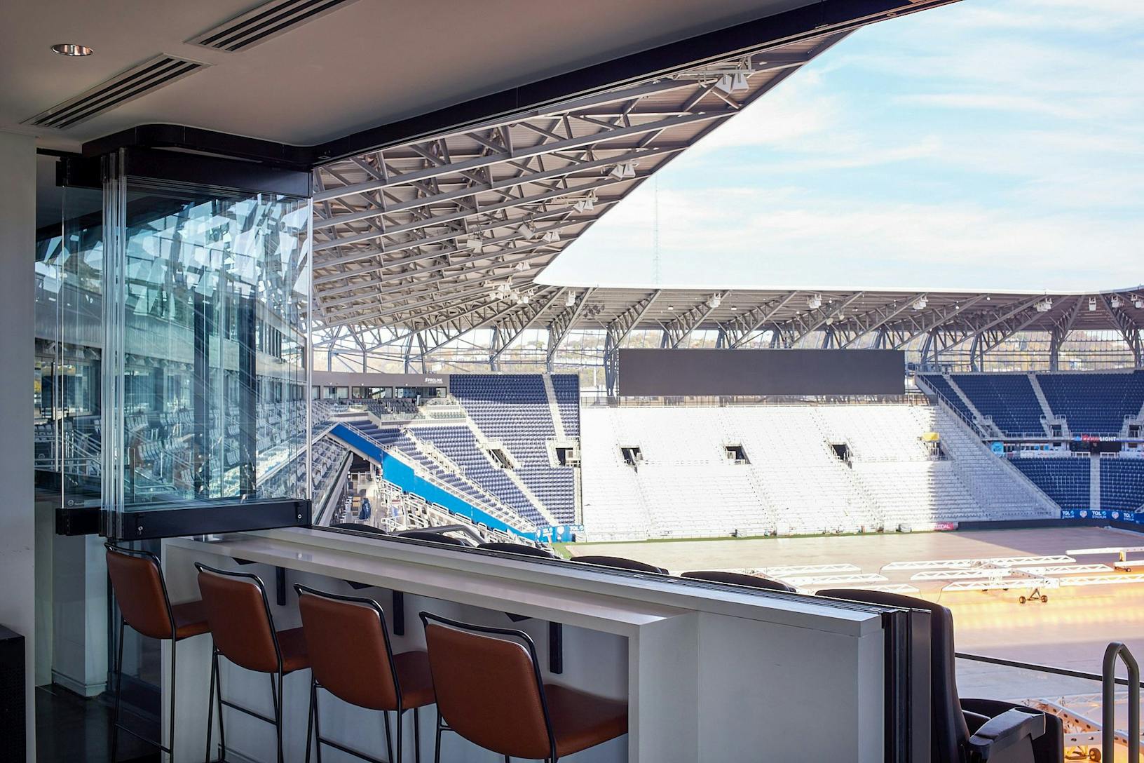 Window door combination sliding glass walls with a view of the TQL stadium
