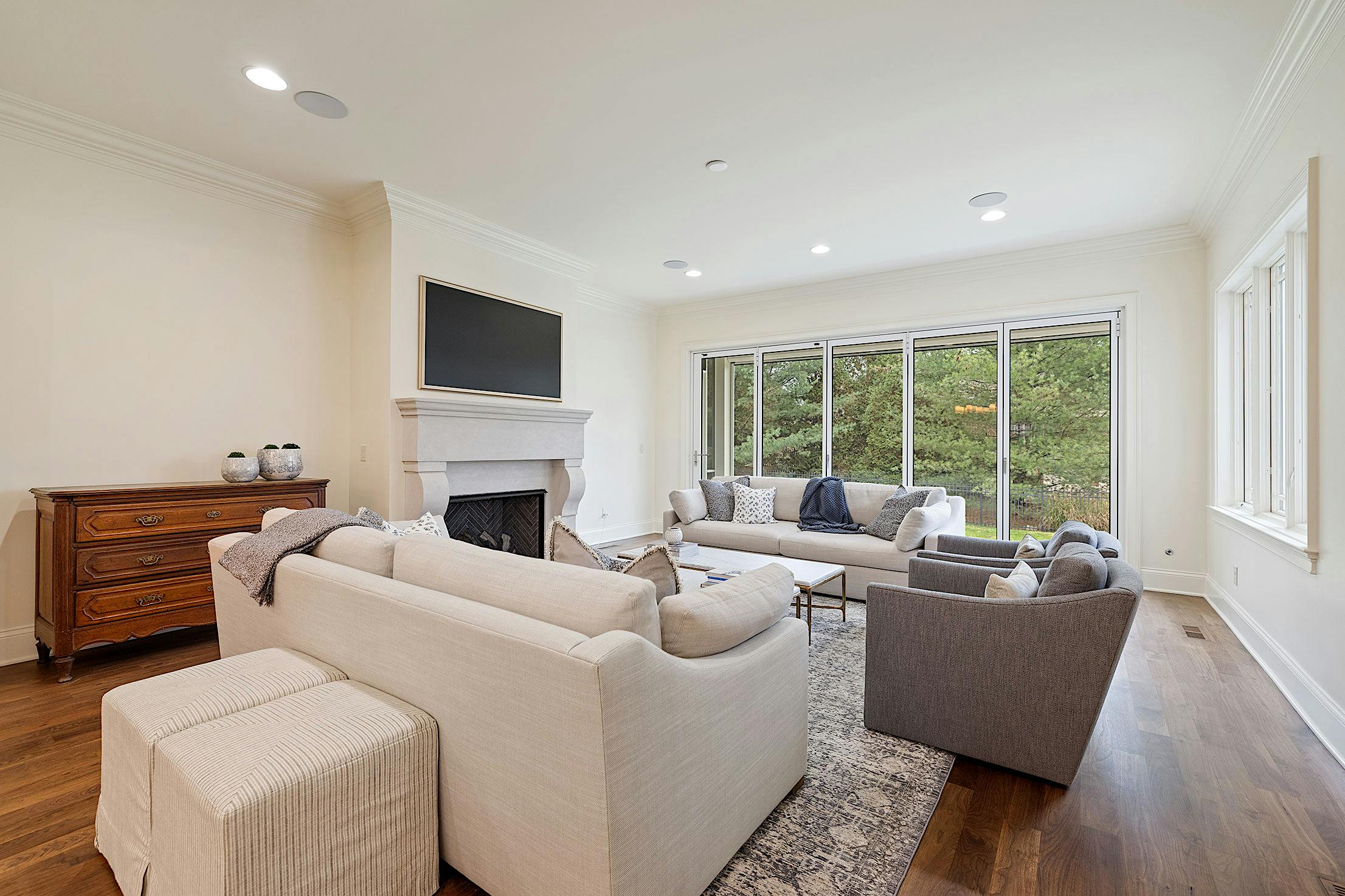 A living room with hardwood floors and an Aluminum Framed Folding Glass Wall