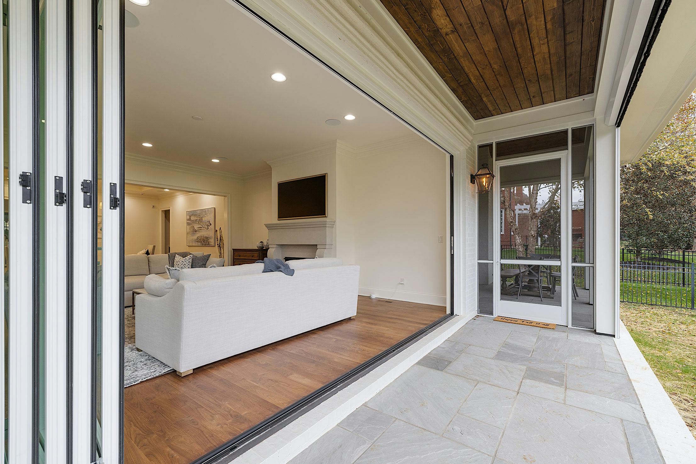 A porch with bifold doors and a grassy area