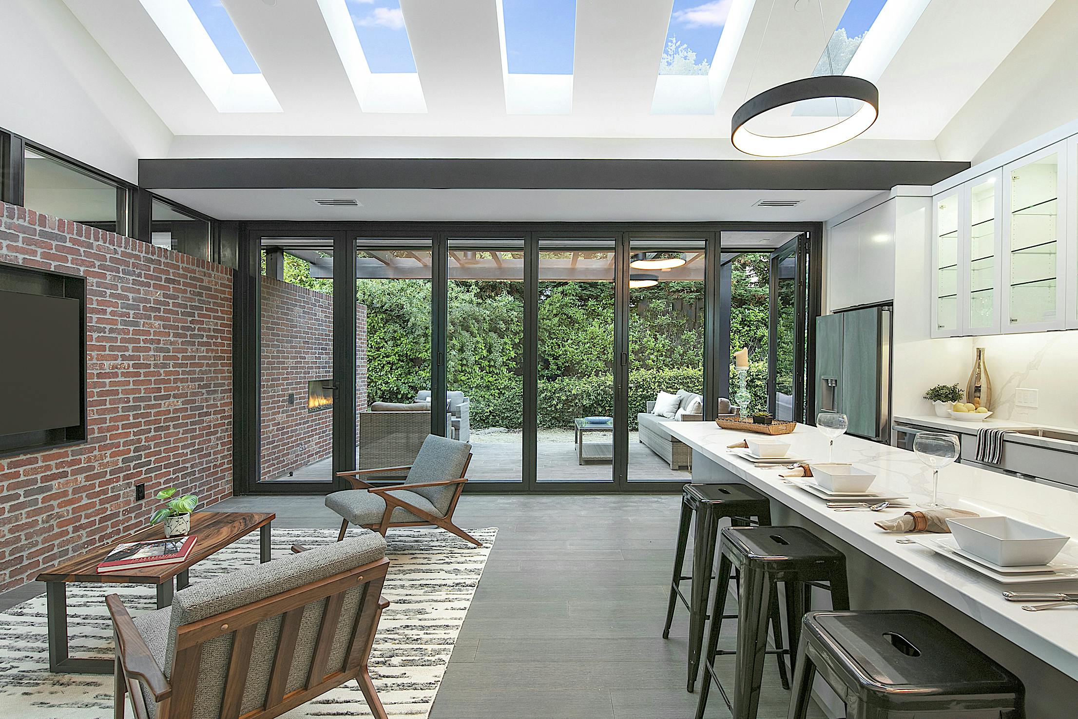 A modern living room interior with Aluminum Clad Folding Glass Walls