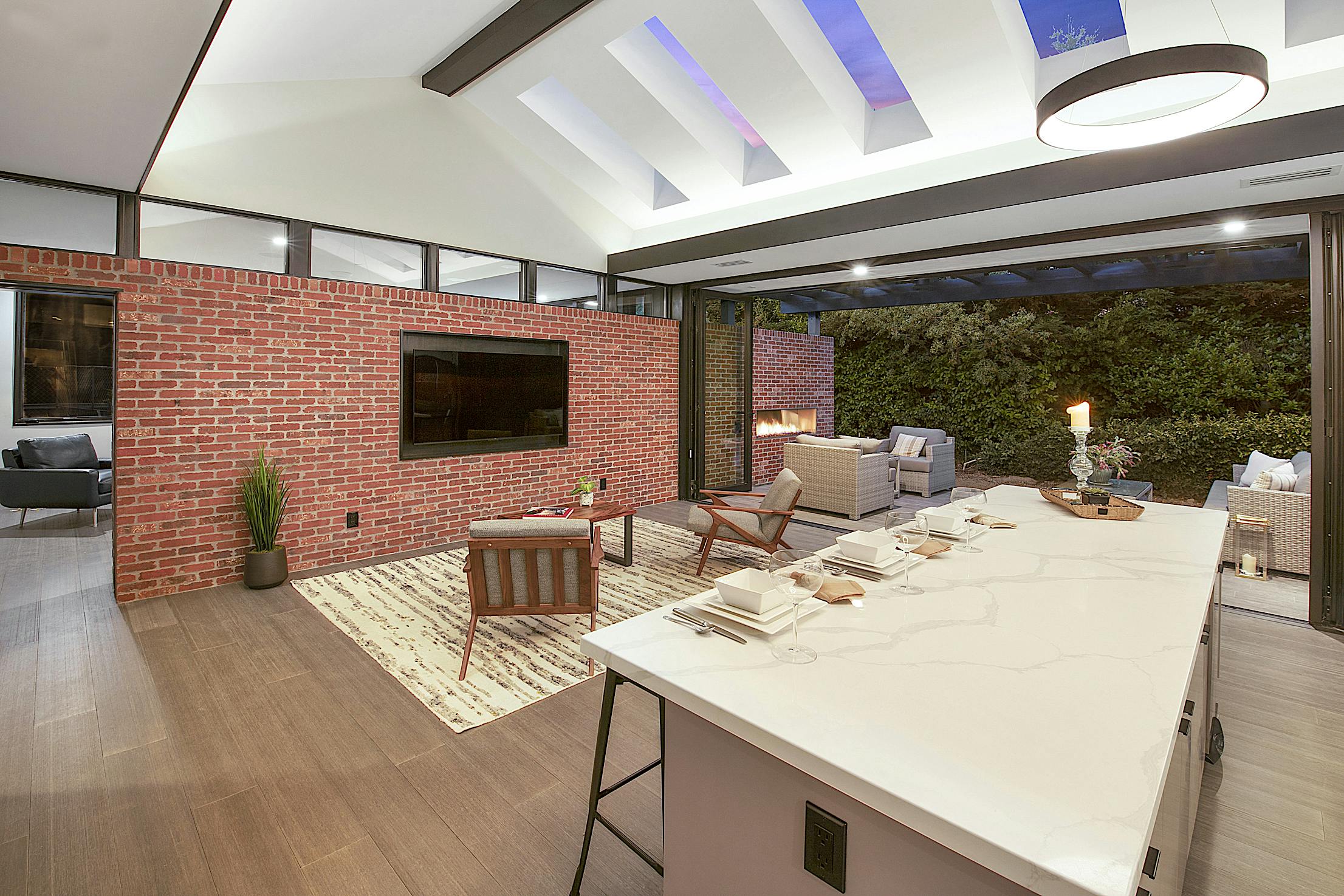 A modern ADU kitchen with an island and folding patio doors
