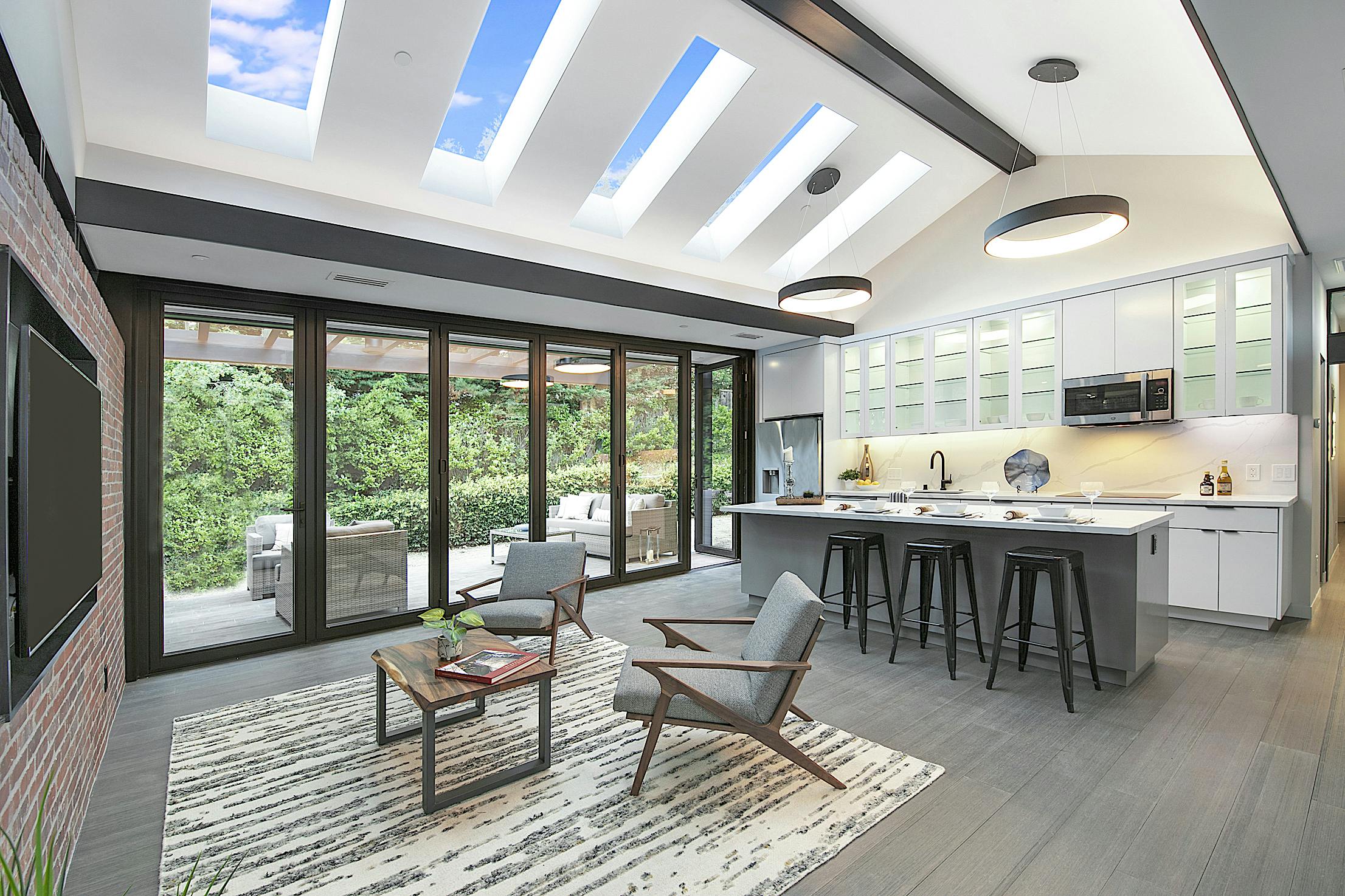 A modern ADU with kitchen and dining room with folding patio doors
