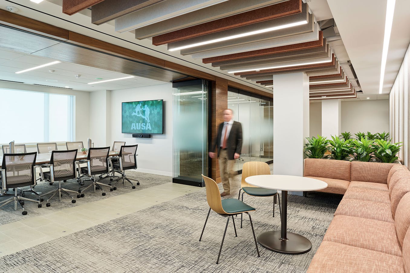 A conference room with a large opening frameless glass walls