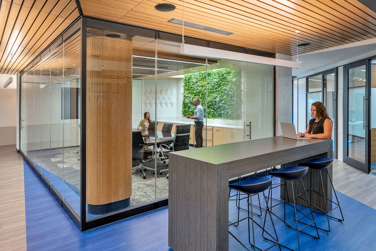 Modern office with frameless sliding glass walls