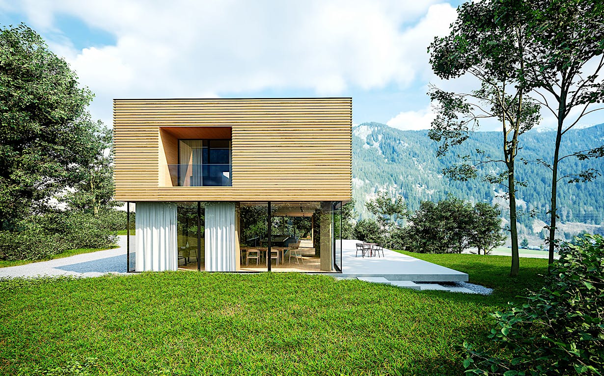 A modern house with sliding patio doors in the mountains.