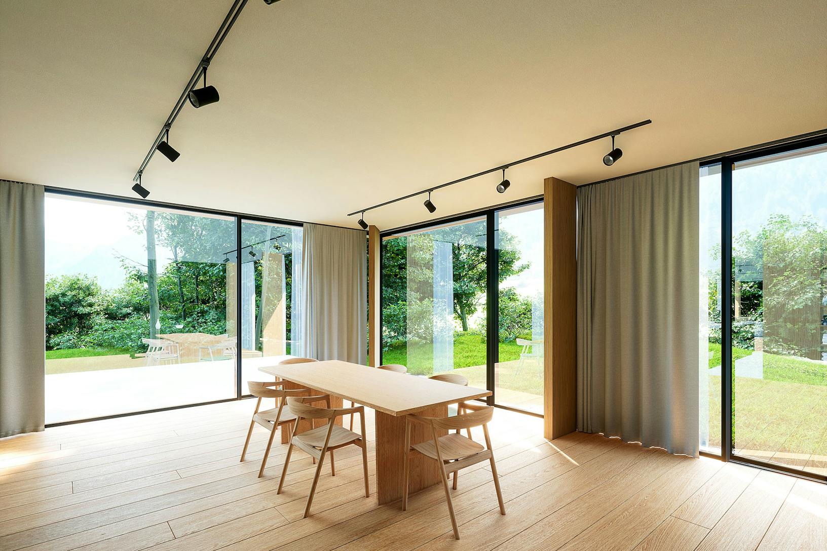 A dining room with minimal sliding glass walls and a wooden table