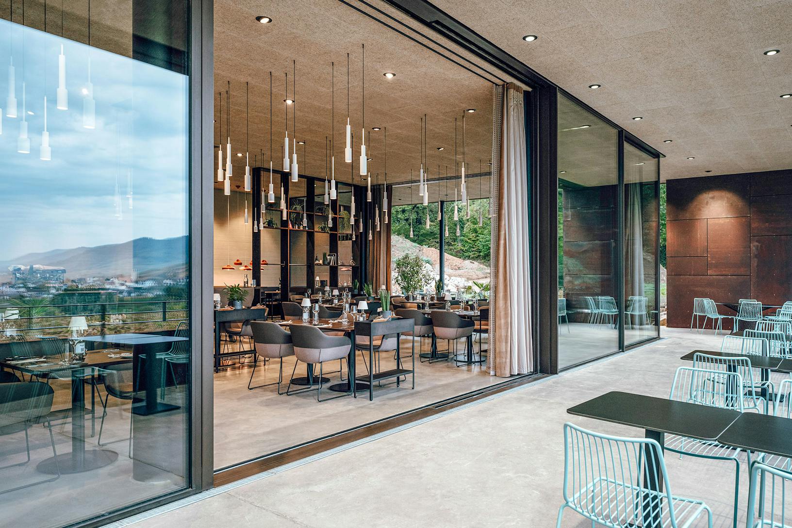Winery with large glass walls overlooking a mountain