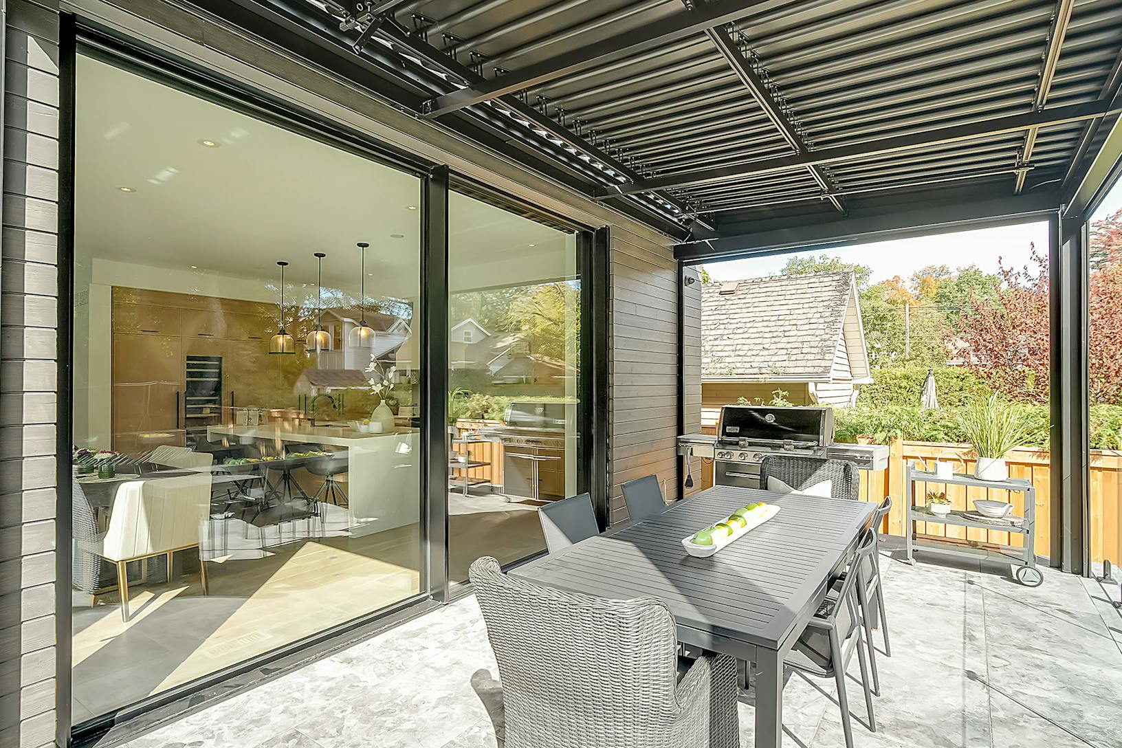 A patio with a dining table and large sliding doors