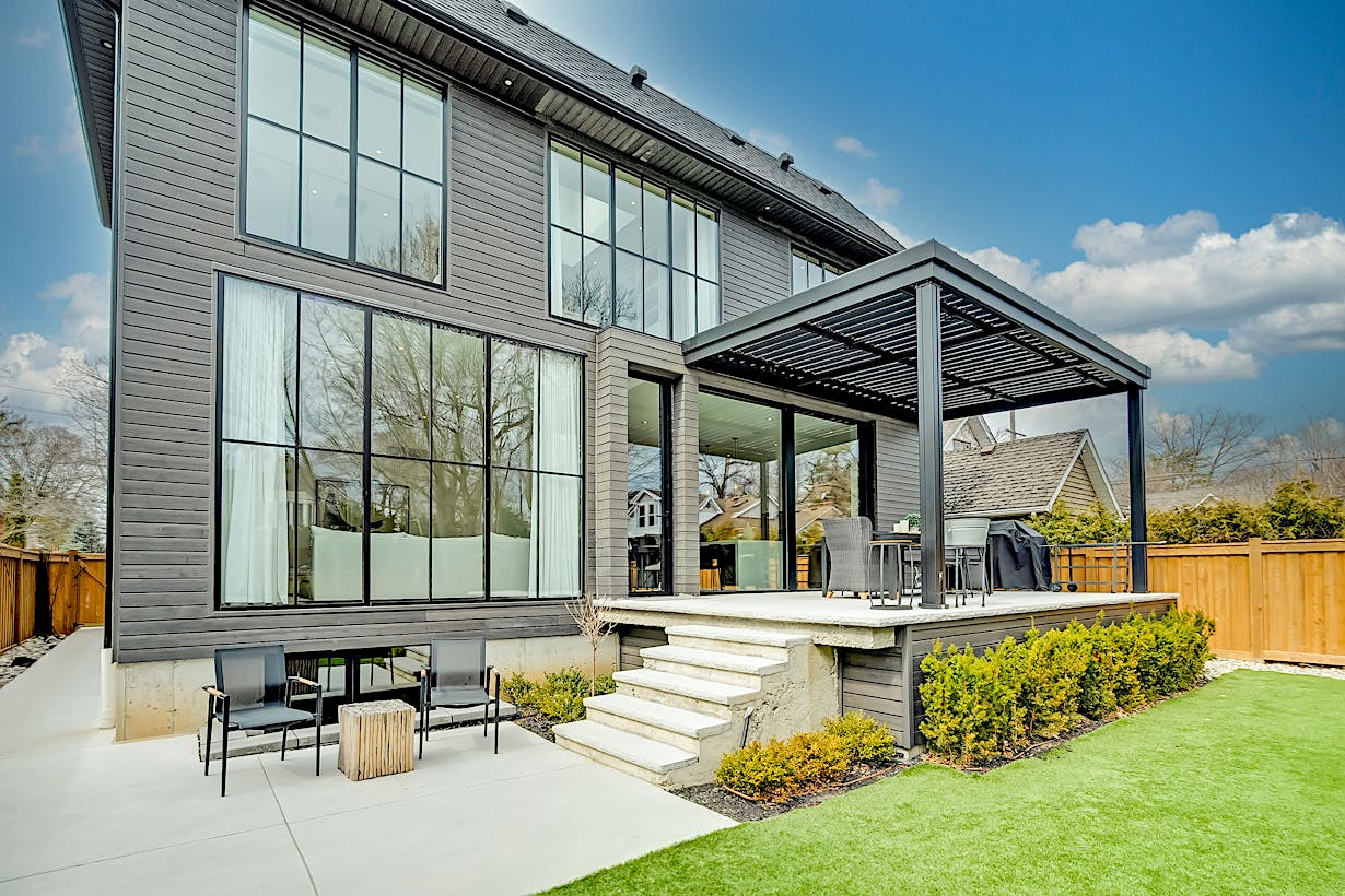 A modern home with a patio and grass