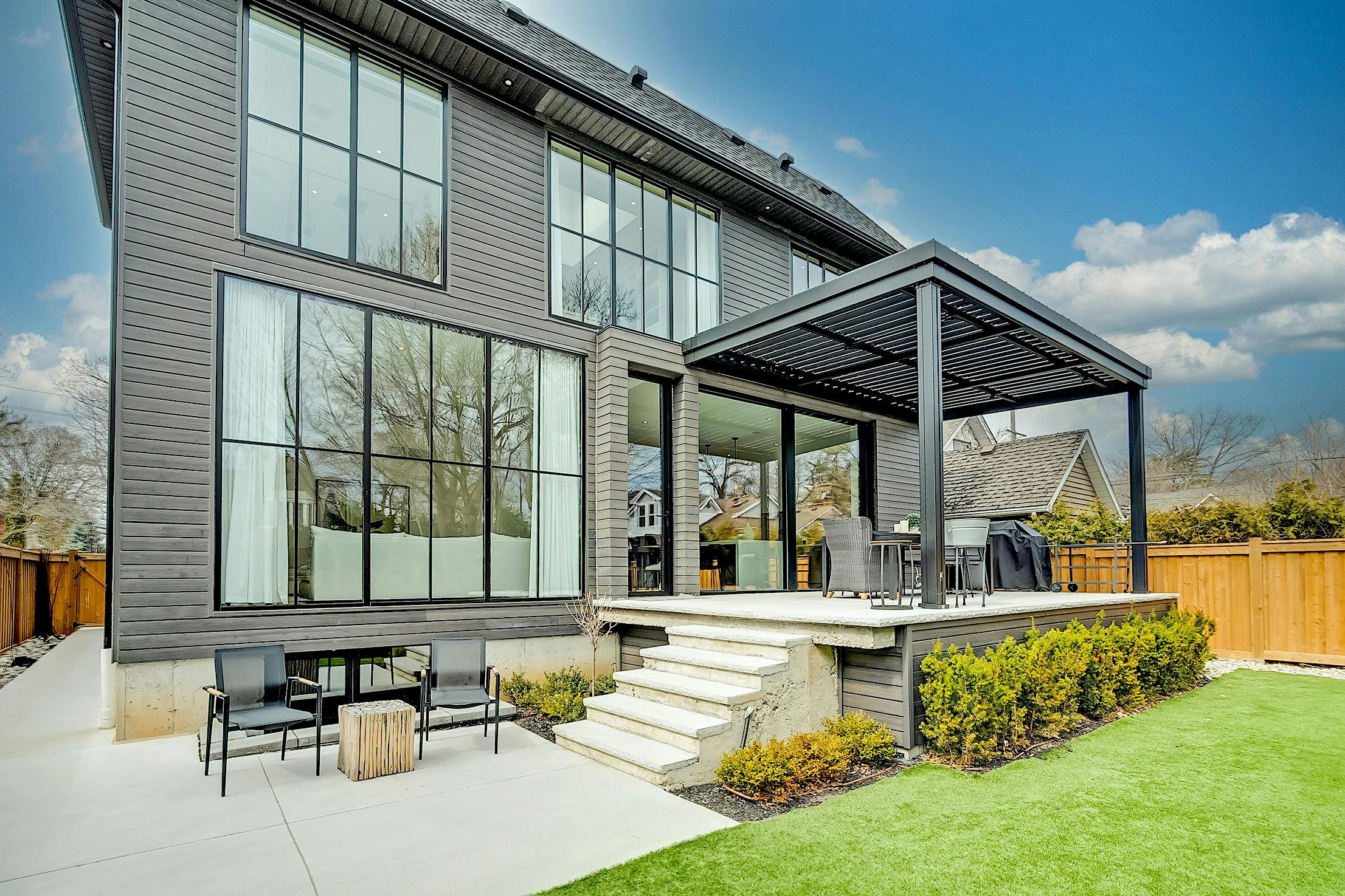 A modern home with a patio and grass