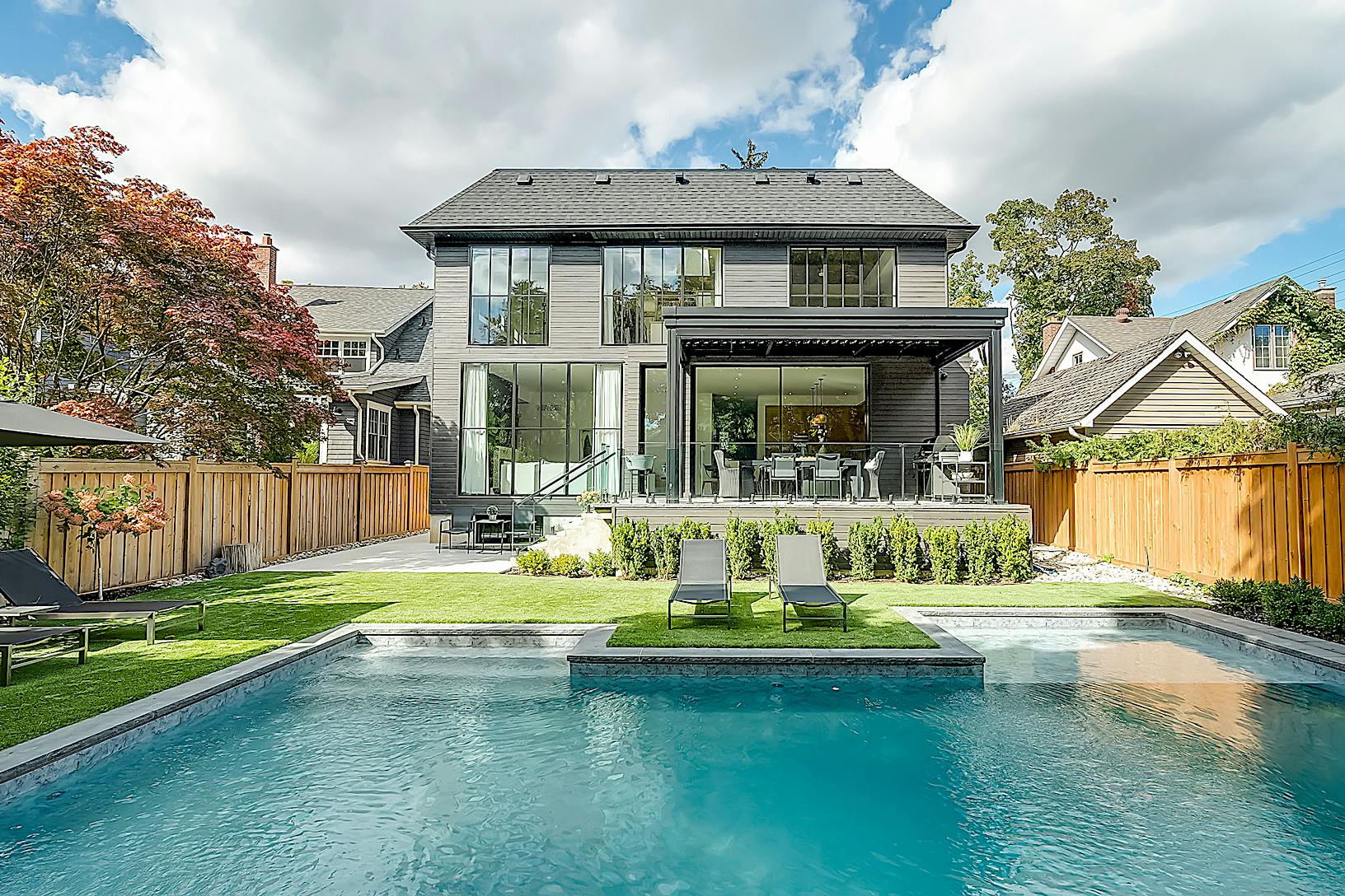 A modern home with a swimming pool in the backyard