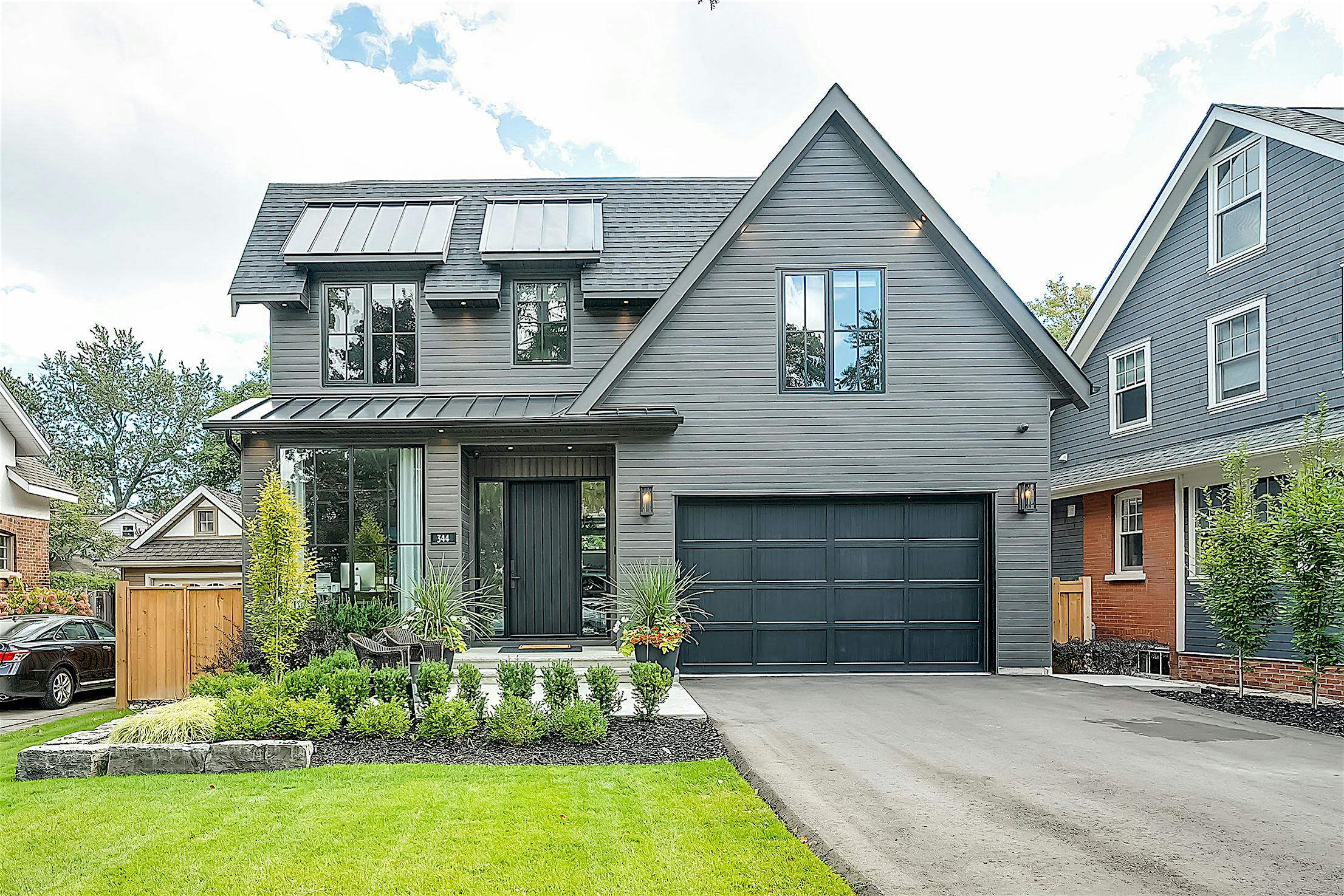 A grey home with a garage and driveway - sliding
