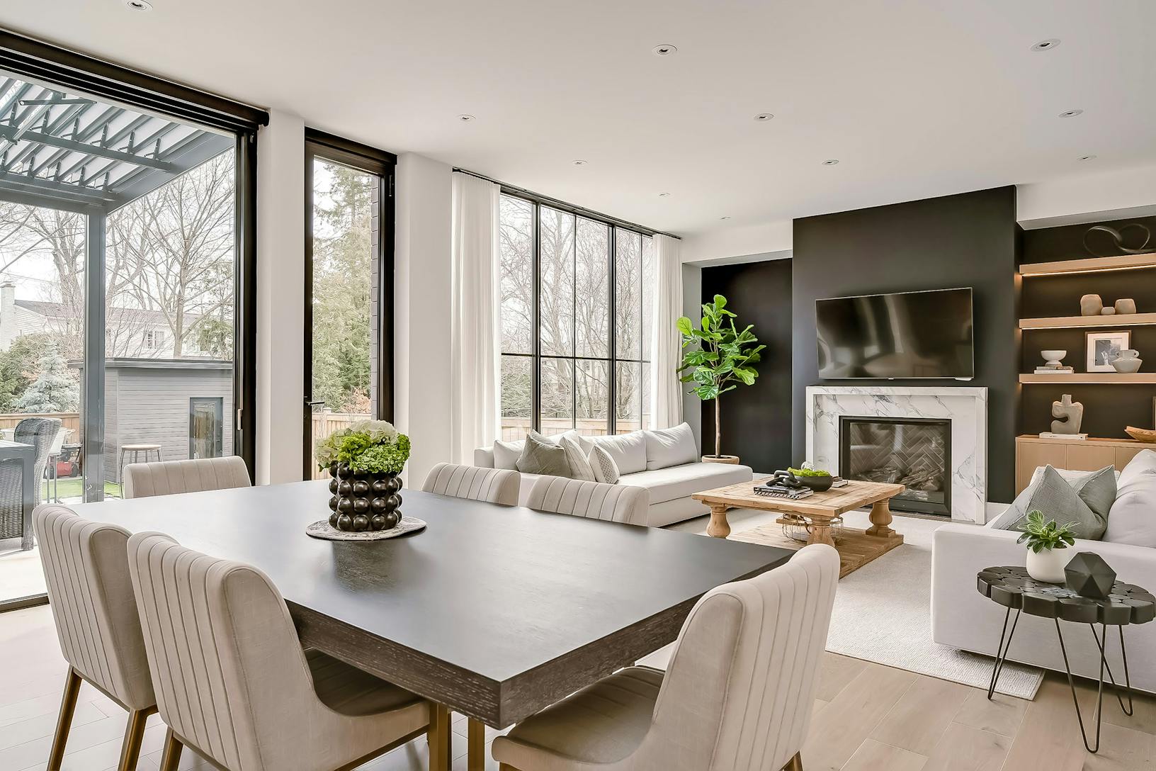 A modern living room featuring minimal sliding glass walls
