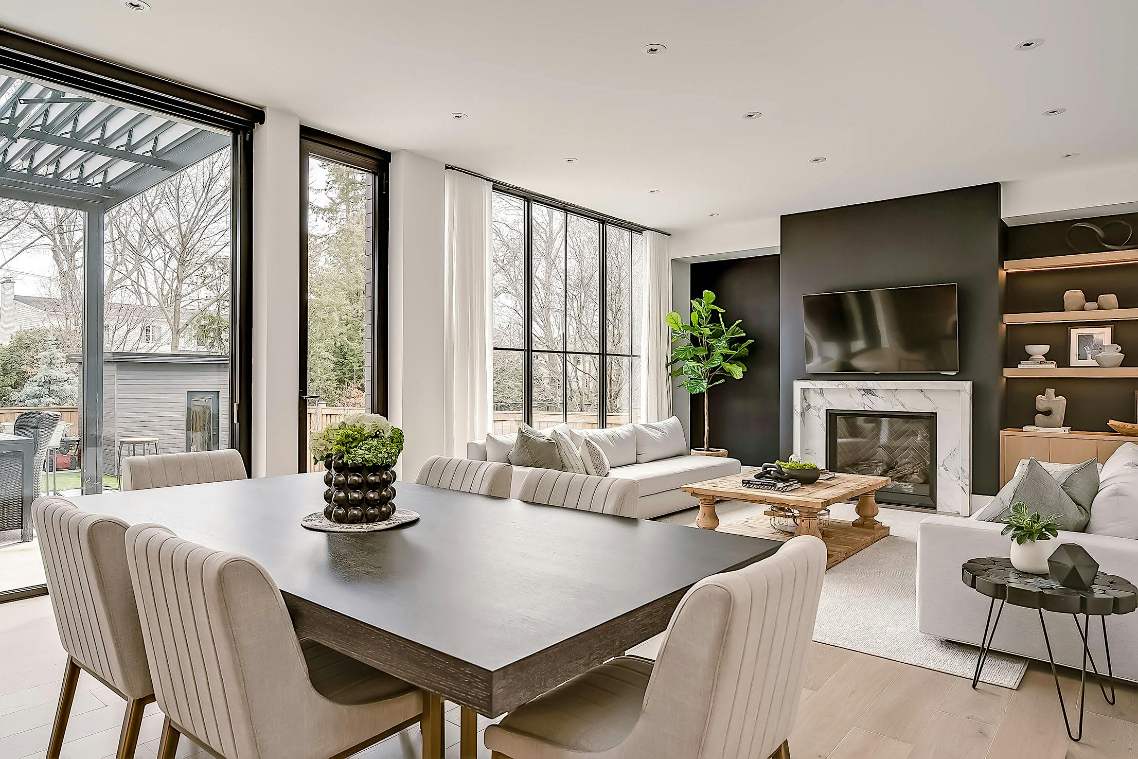 A modern living room featuring minimal sliding glass walls