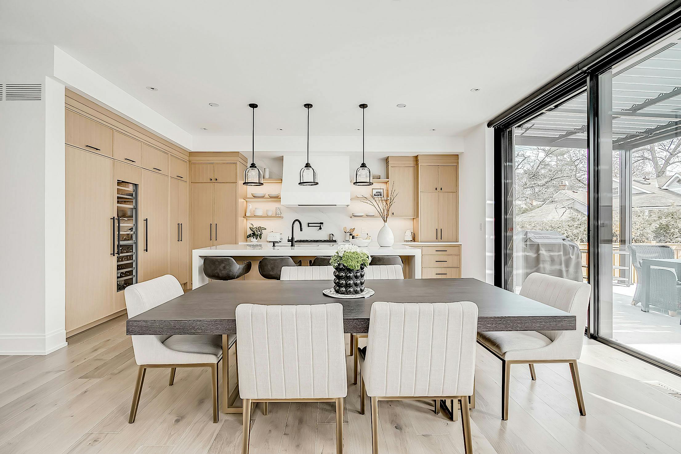 A modern dining room with sliding glass walls