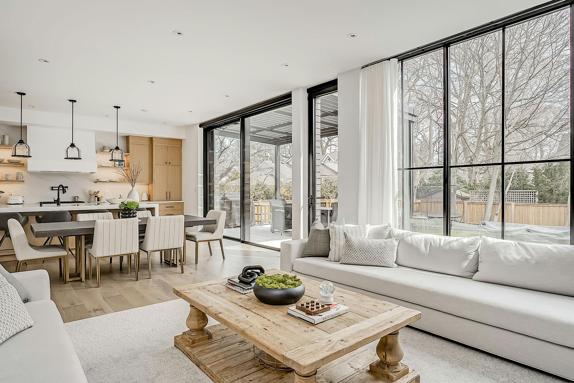 A modern living room with large minimal sliding doors