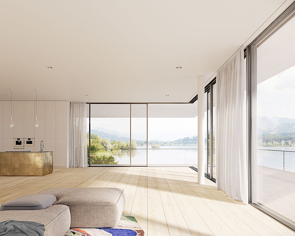 A living room with sliding patio doors offering a view of a lake