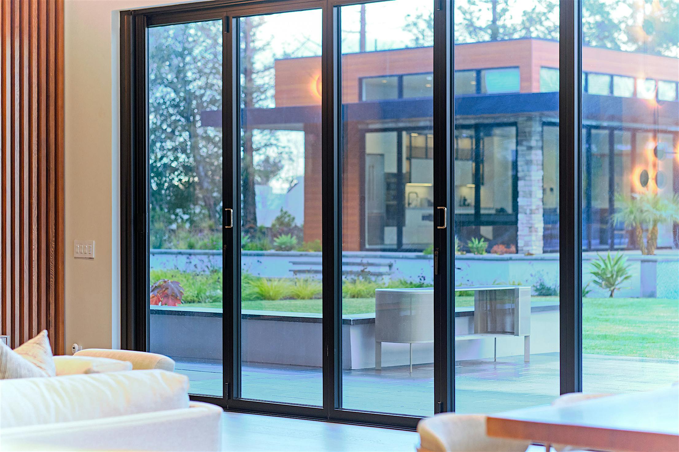 A living room with large opening folding patio doors