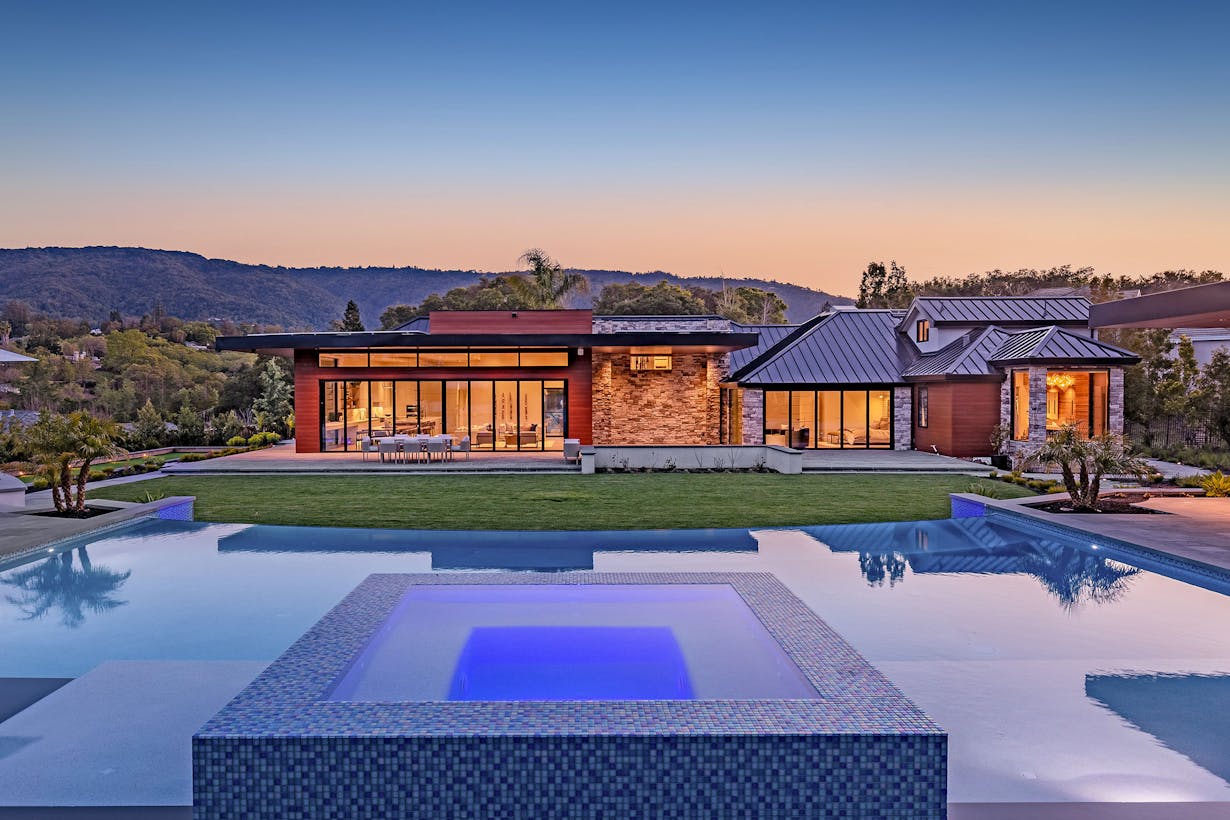 A modern home with a large swimming pool and folding glass walls tested for forced entry
