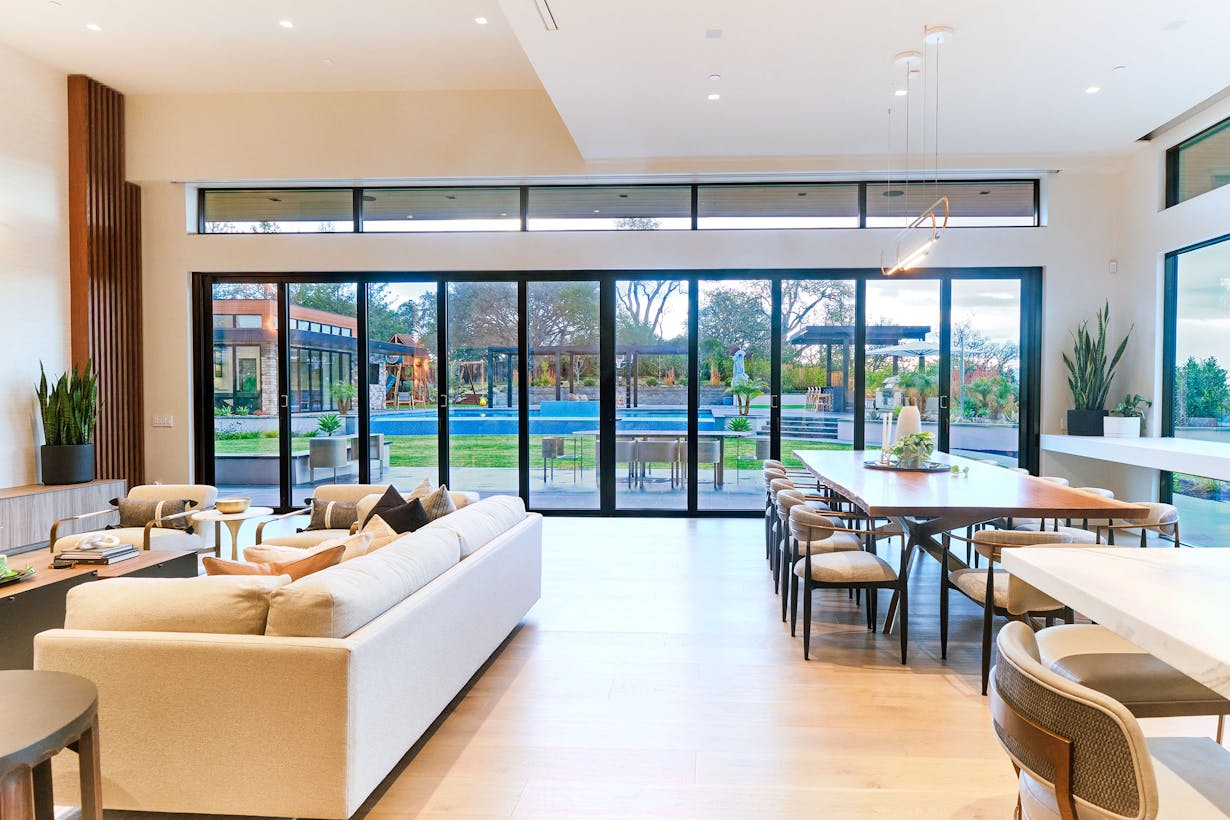 A modern living room with sliding glass doors that have been tested for forced entry