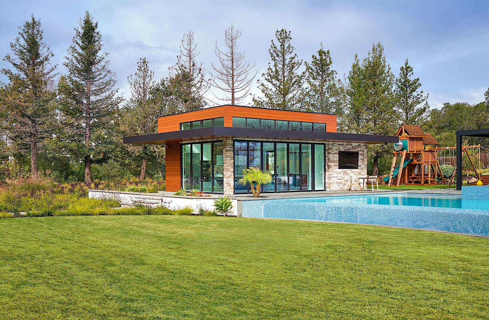 A house featuring a swimming pool and folding patio doors