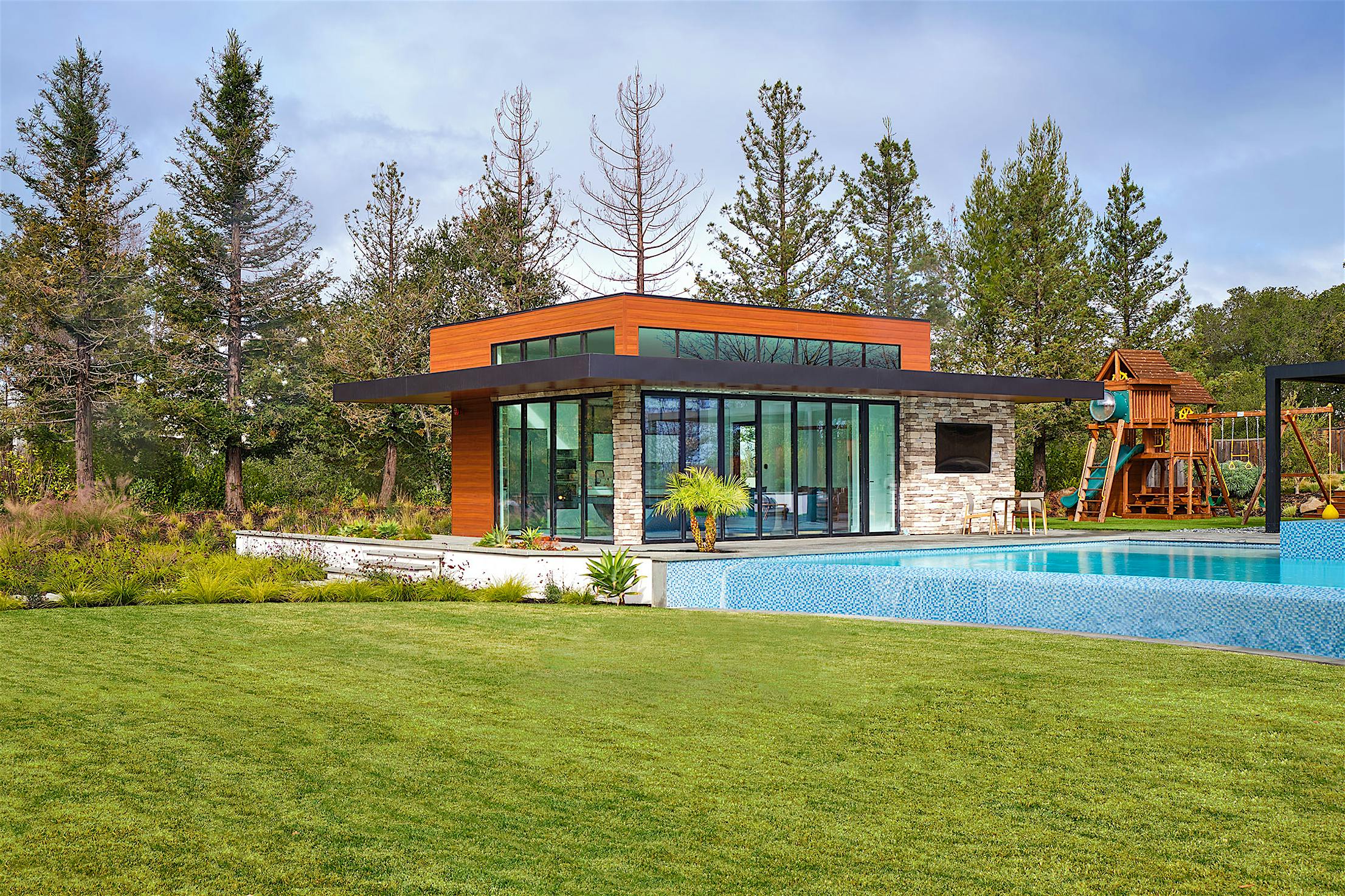 A house featuring a swimming pool and folding patio doors