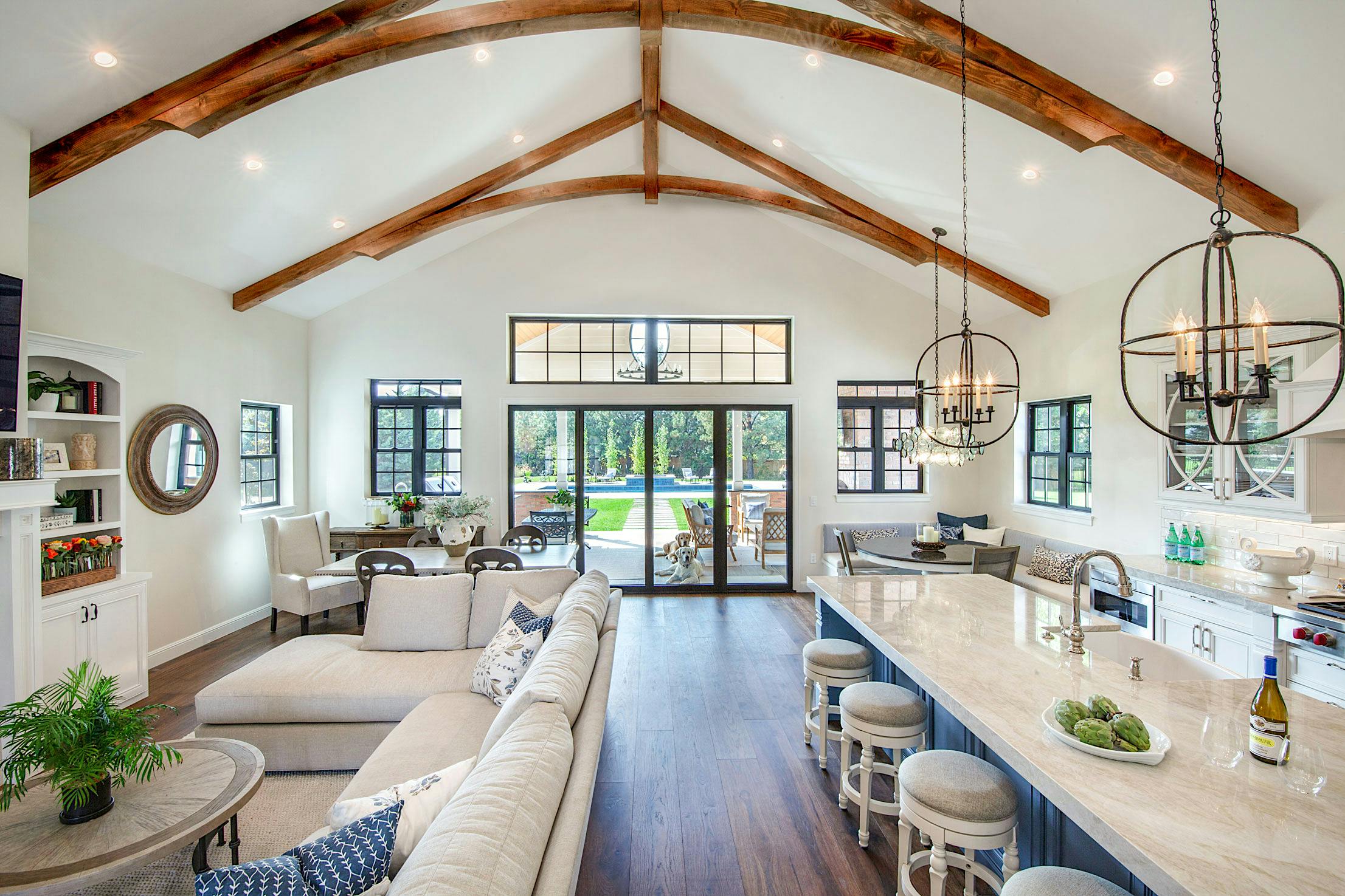 A large open kitchen and living room with folding patio doors