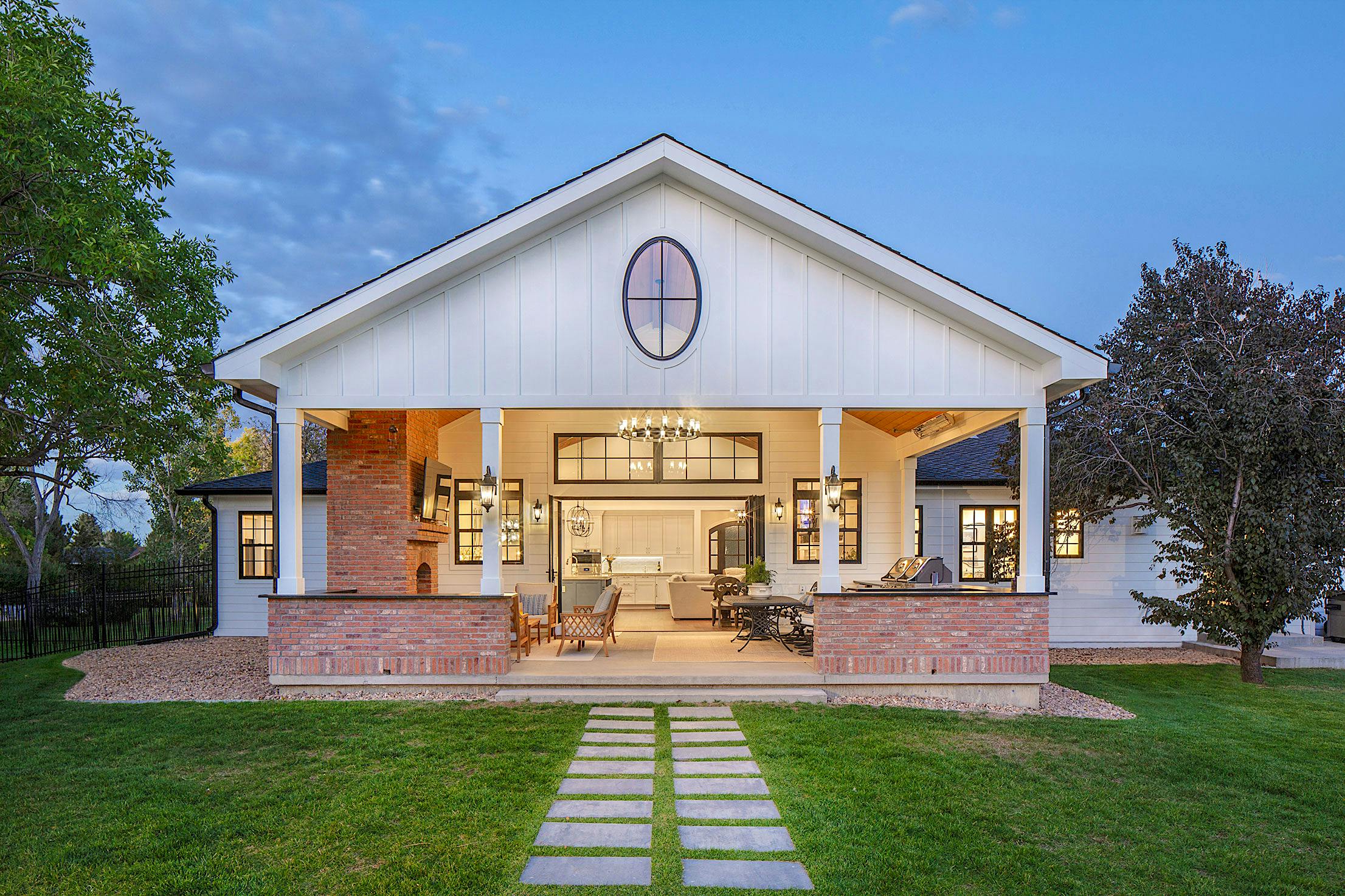 A home with a large front porch featuring folding glass panels