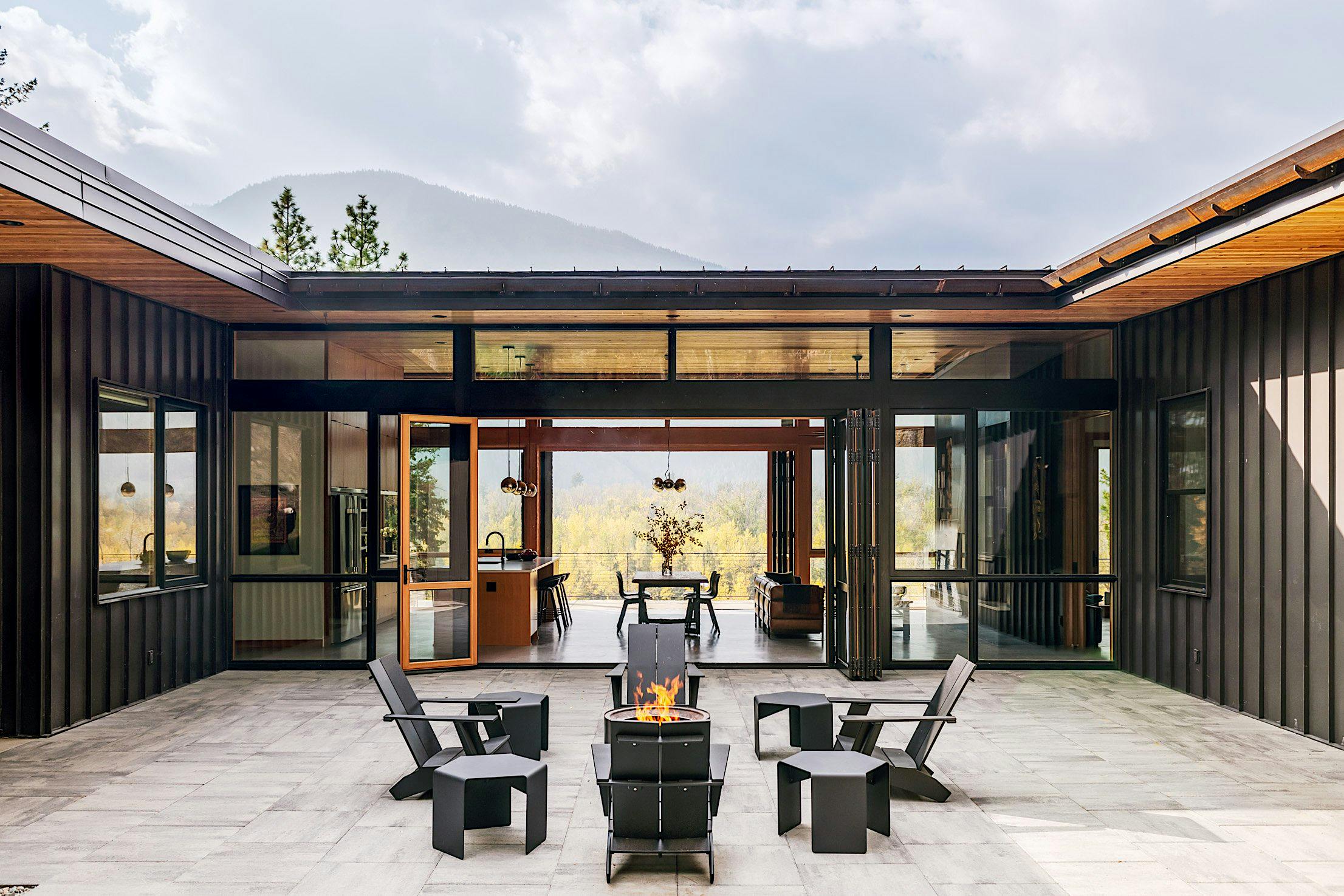 Folding exterior doors create seamless transitions for indoor-outdoor living at Edelweiss Residence in Washington