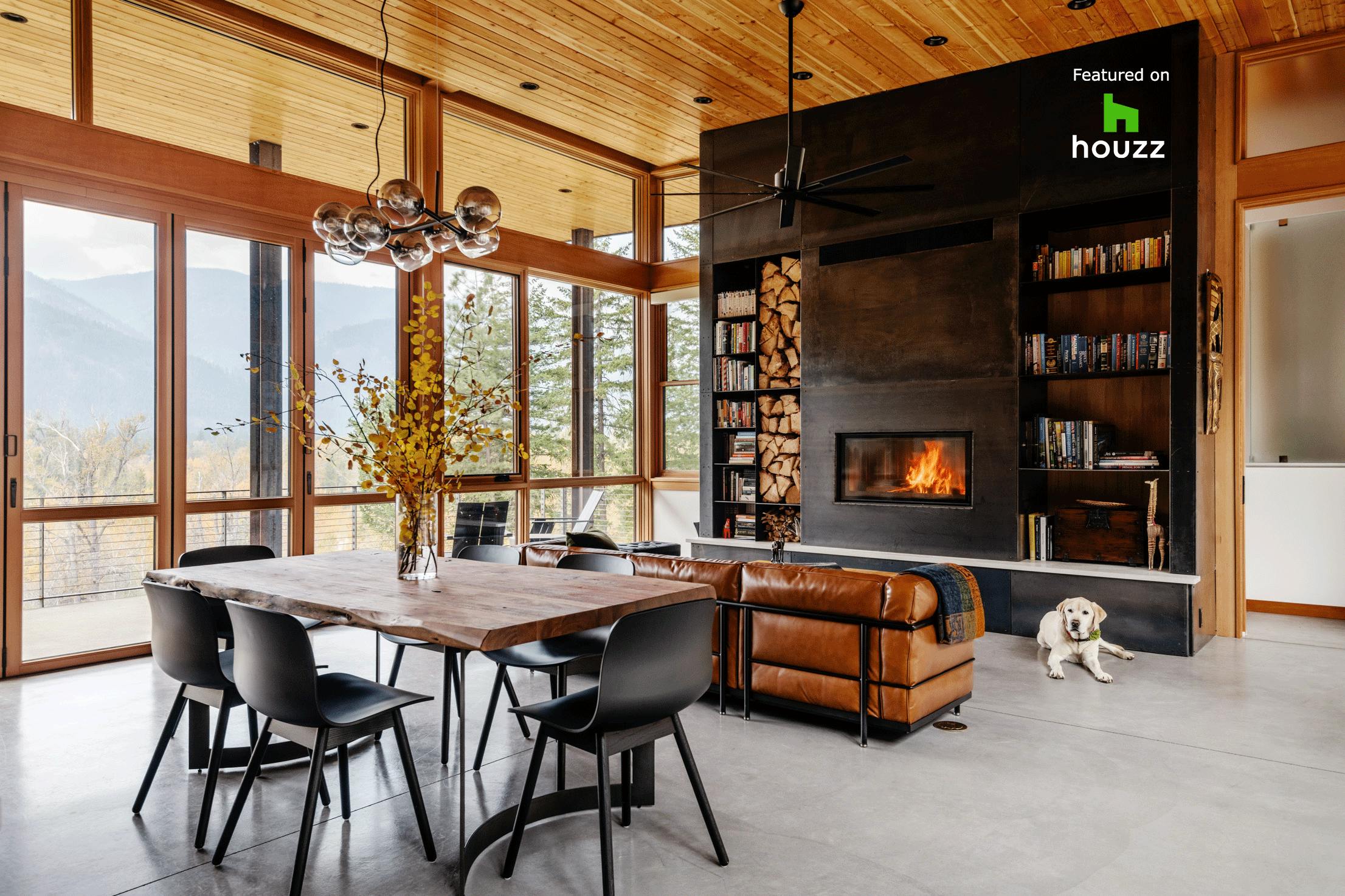 Interior living space with folding glass doors opened to the deck, part of a Houzz-featured project highlighting warm wood finishes and indoor-outdoor living