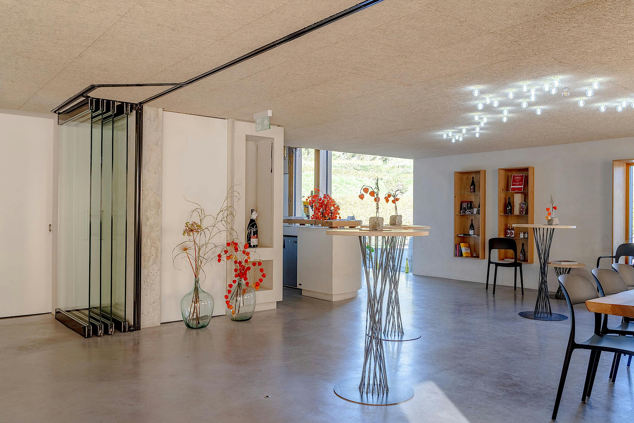 Modern wine tasting room interior, glass partition walls stacked in parking bay .